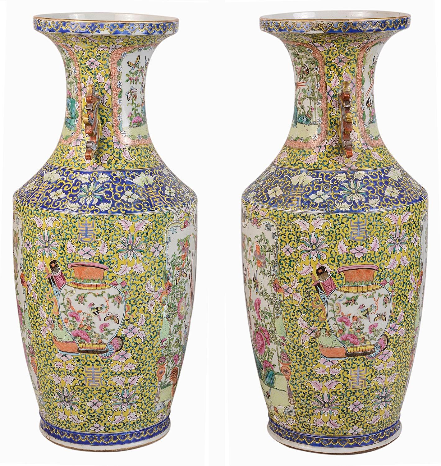 A beautiful pair of 19th century Chinese rose medallion / Cantonese vases, each with wonderful classical motif decorations in yellows, blue backgrounds. Inset hand painted panels of exotic birds, flowers and butterflies. Raised in gilded wooden