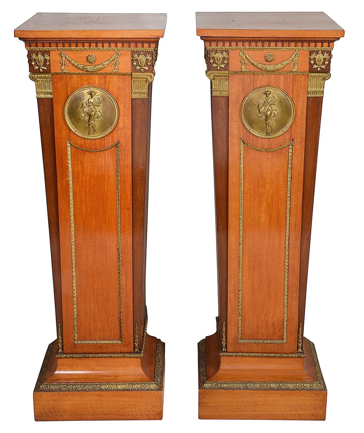 A very good quality pair of late 19th century mahogany veneered classical tapering pedestals to support sculpture. Each with wonderful gilded ormolu mounts, mouldings and plaques.

UNYKZ. 61458. Batch 69.