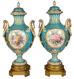 Pair 19th Century classical Sevres style lidded vases.