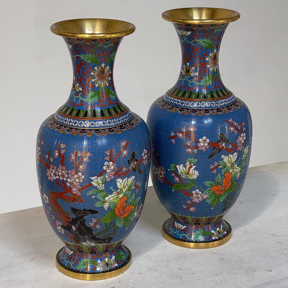 Pair 19th Century Cloissone vases is an extraordinary example of the breed, displaying its well-preserved, rich coloration and exhibiting a large format design theme celebrating the natural beauty of flowers. Decorated in the round, brass wire was