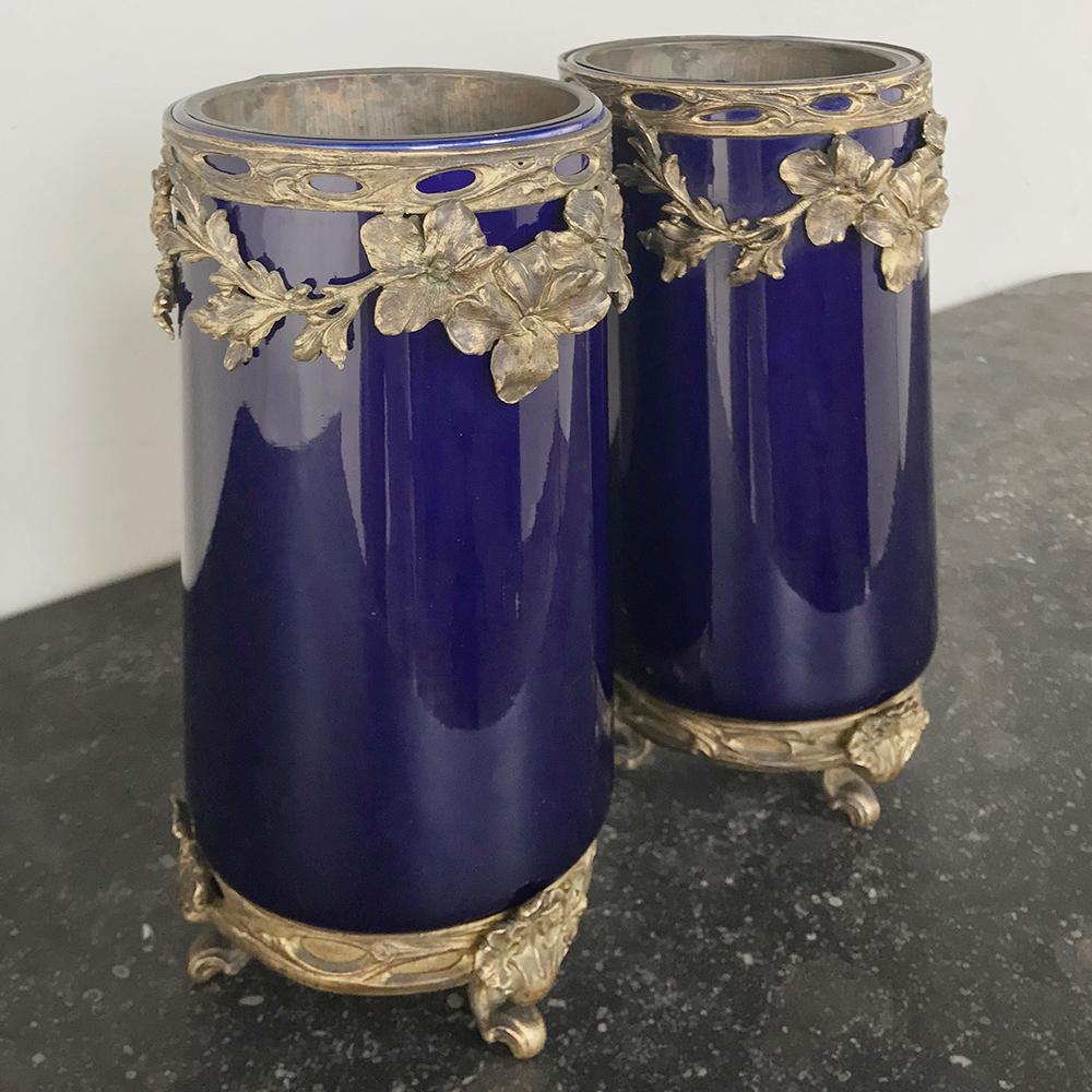 Pair of 19th century cobalt and bronze vases represent the epitome of the genre, with the luxurious deep cobalt blue porcelain, named after the mineral cobalt which imparts the unique color. Surrounded in cast bronze for opulence, the pair will make