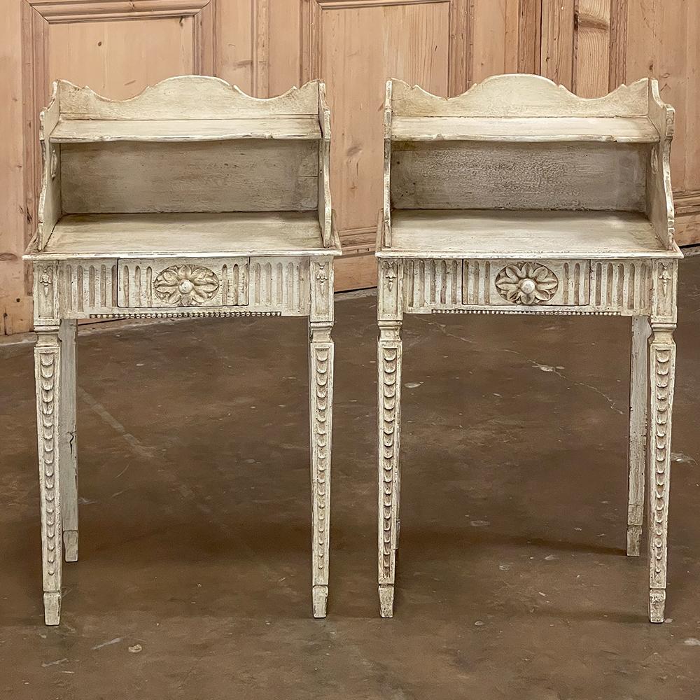 Pair 19th century Country French Louis XVI painted nightstands is a charming example of the combination of classical architecture and rustic French charm! A wraparound backsplash encompasses a candle shelf above, and encloses the main surface to