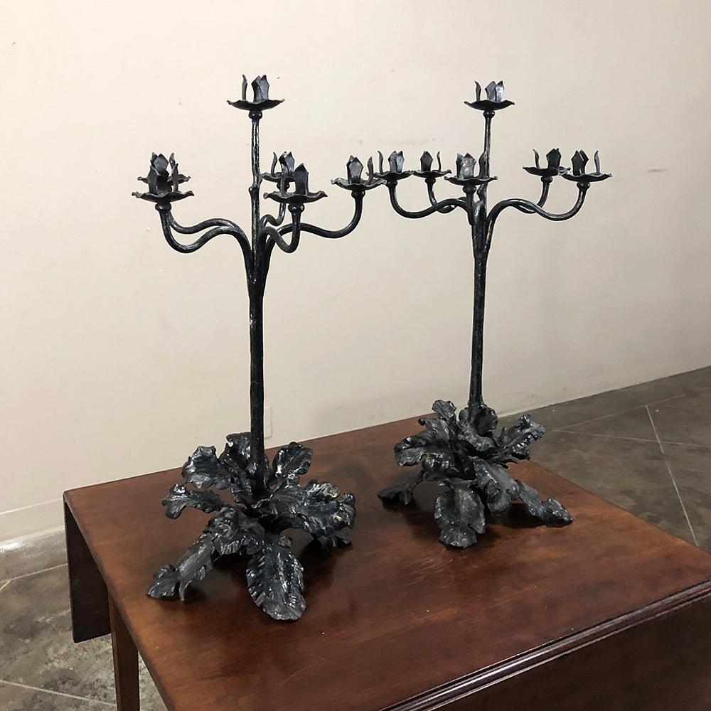 Pair of 19th century Country French wrought iron candelabra exhibit amazing artistry, and were both completely forged by hand by an obviously talented metalsmith,

circa 1840s

Each measures 23 height x 12 in diameter.