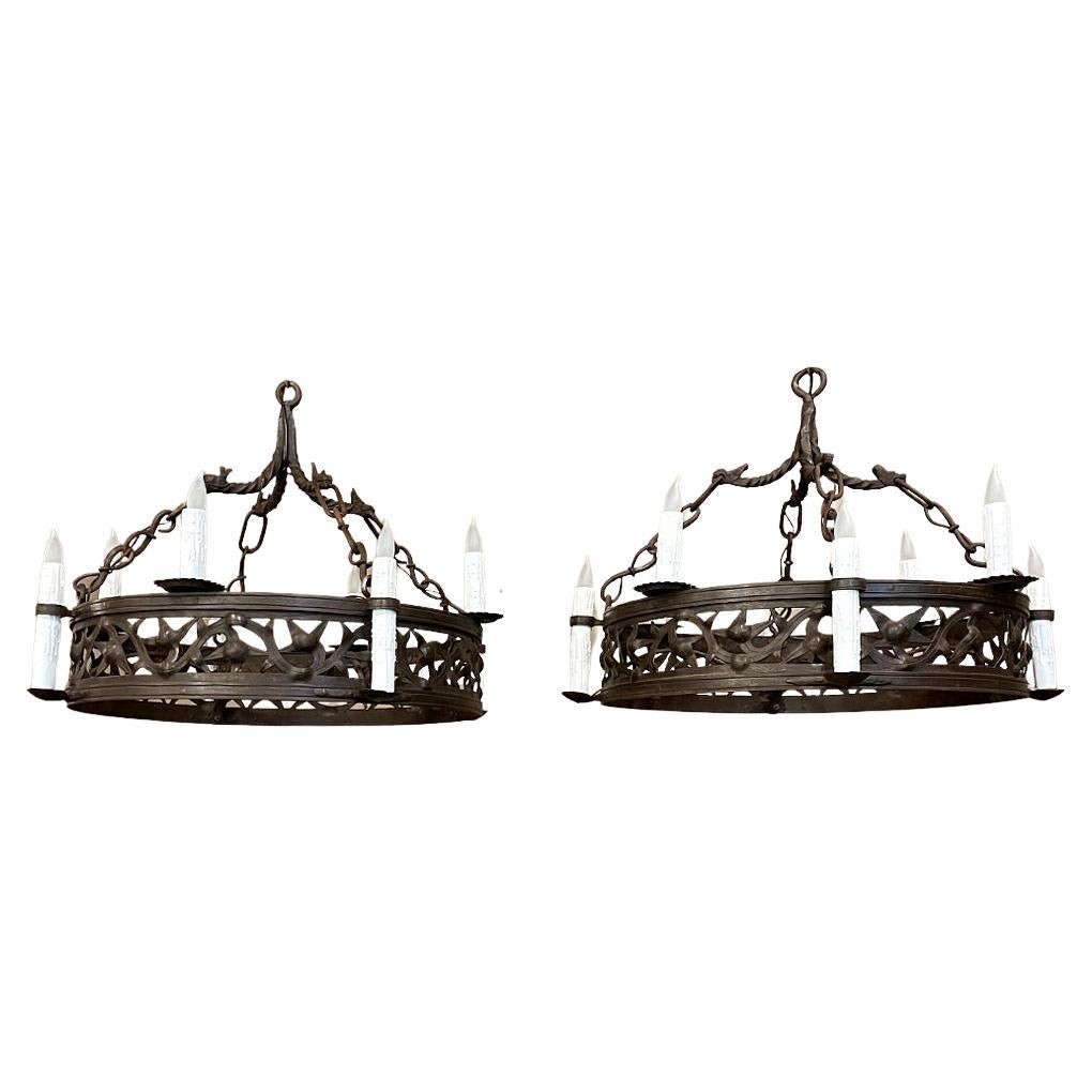 Pair Antique country french wrought iron chandeliers is a rare find indeed! Each has been completely forged by hand from red-hot iron over the blacksmith's anvil. First, the Dual hoops were fashioned, then welded together with an intriguing