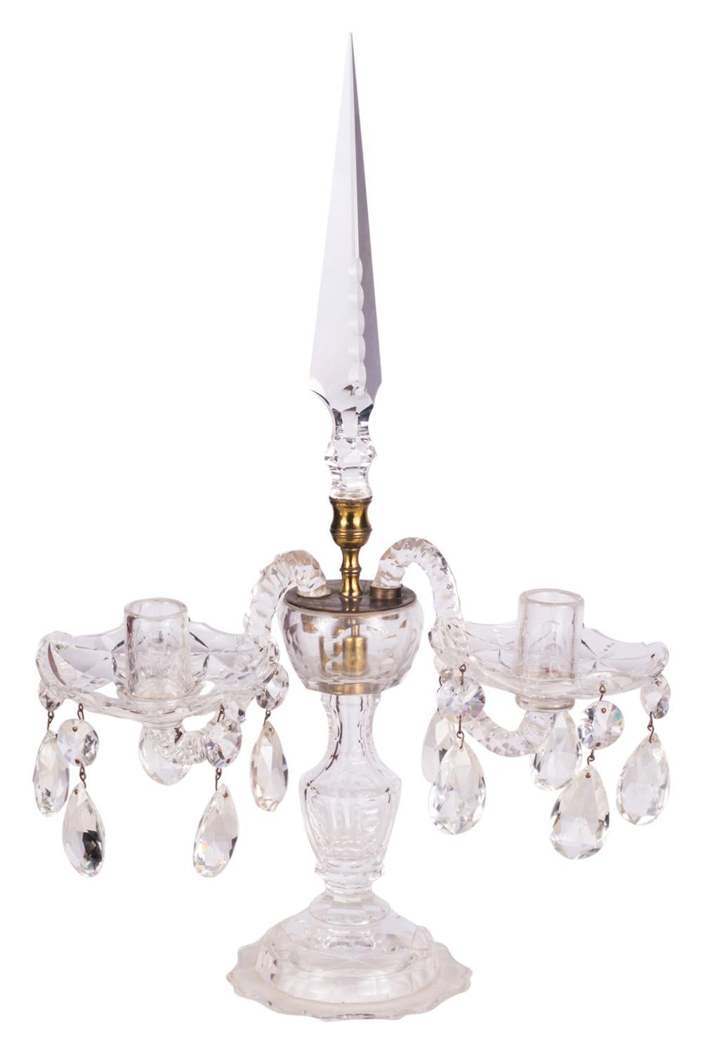 A good quality pair of 19th century cut glass two branch candelabra, having pendant drops hanging from the drip pans and supported by glass pedestal bases.