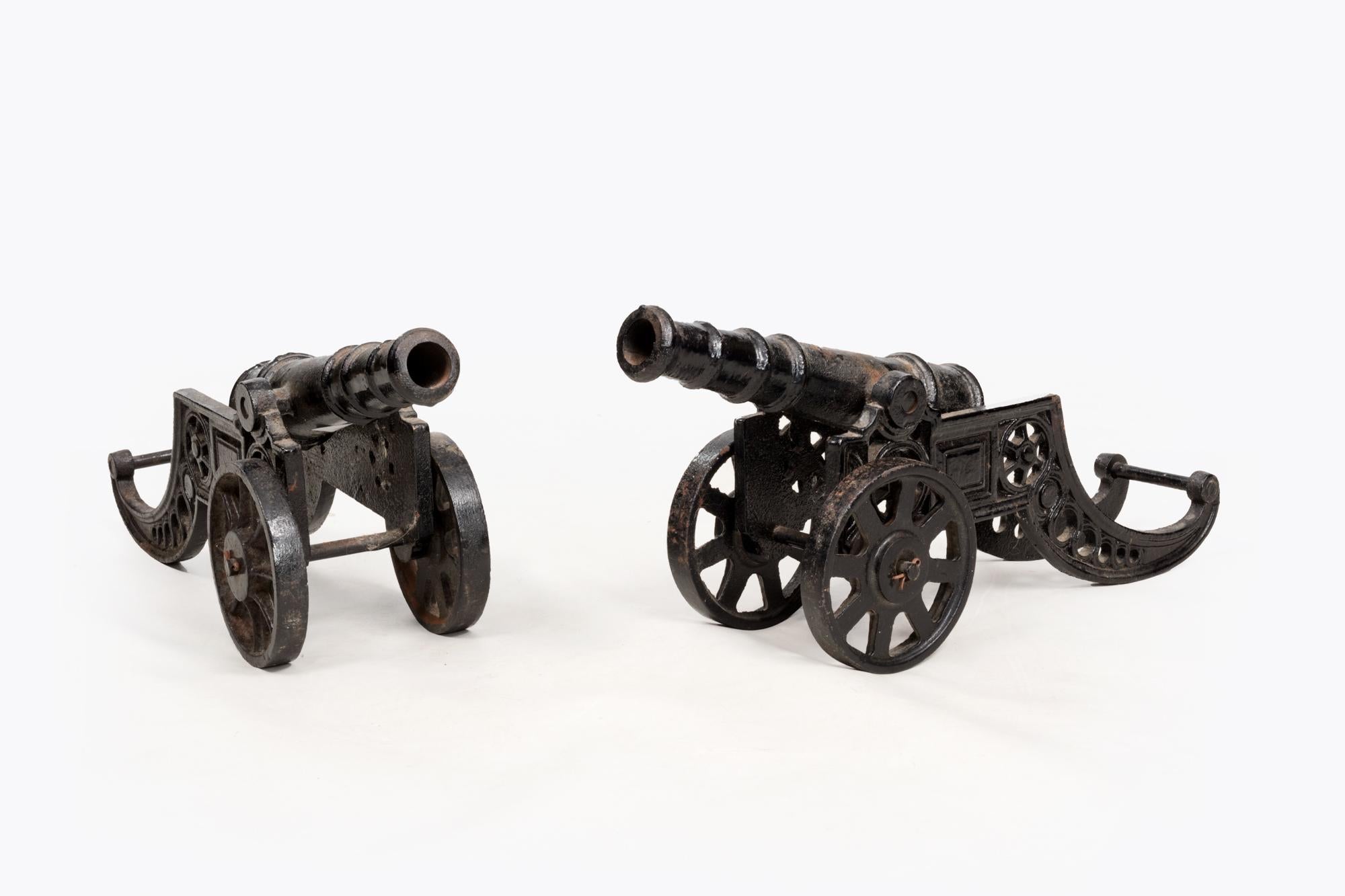 Pair 19th Century decorative desktop cast iron signalling cannons set on carriages with working wheels.