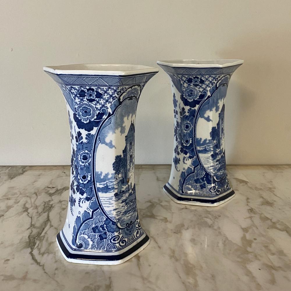 Pair of 19th century delft blue and white vases are excellent examples of the fine artistry in porcelain that have been produced in the region for centuries! Deep, rich cobalt blue was used to paint a chateau scene as the primary image, surrounded