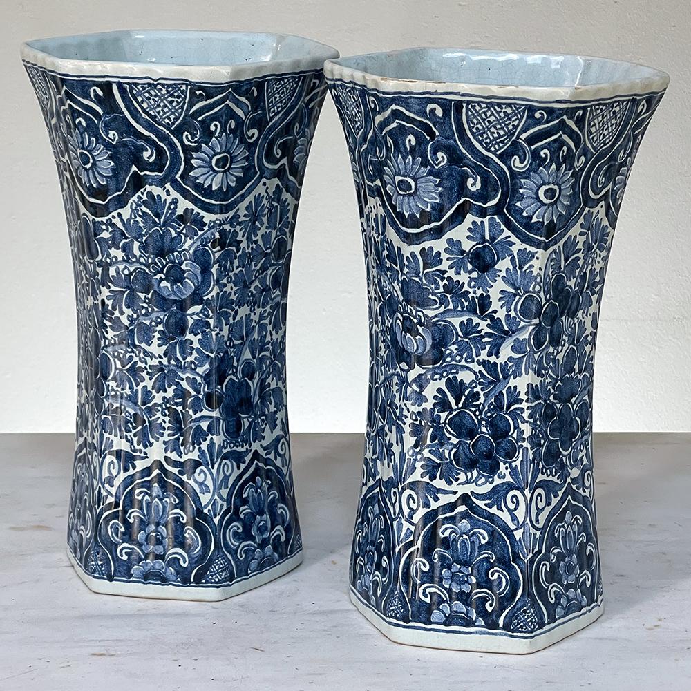 Pair 19th century Delft hand-painted blue & white vases are a splendid collectible that was created for the lucrative European market during the latter 1800s, where the clay was treated with a tin solution before glazing resulting in a unique and