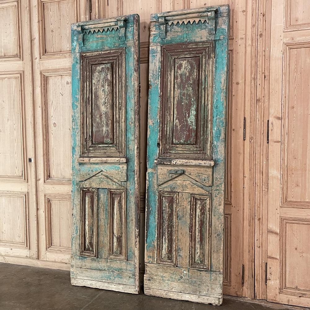 Pair 19th century East European oak exterior doors are perfect for adding a rustic, timeless charm to your entryway or passageway! Hand-crafted from old-growth oak, each features an intriguing crown flanked by corbels appearing above the raised