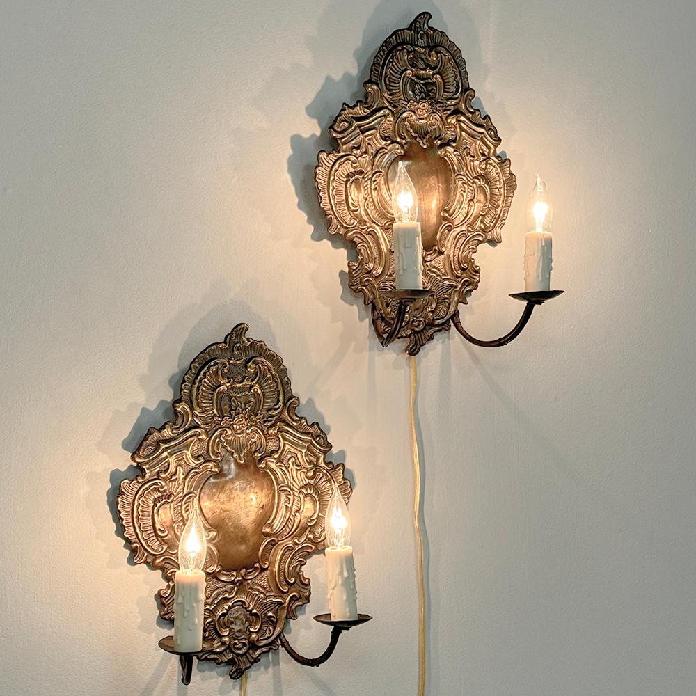 Pair 19th Century Embossed Brass Baroque Wall Sconces feature elaborate detail embossed from solid brass that has achieved a lovely patina over the past century and a half!  Originally intended for candles, each has been expertly wired to US