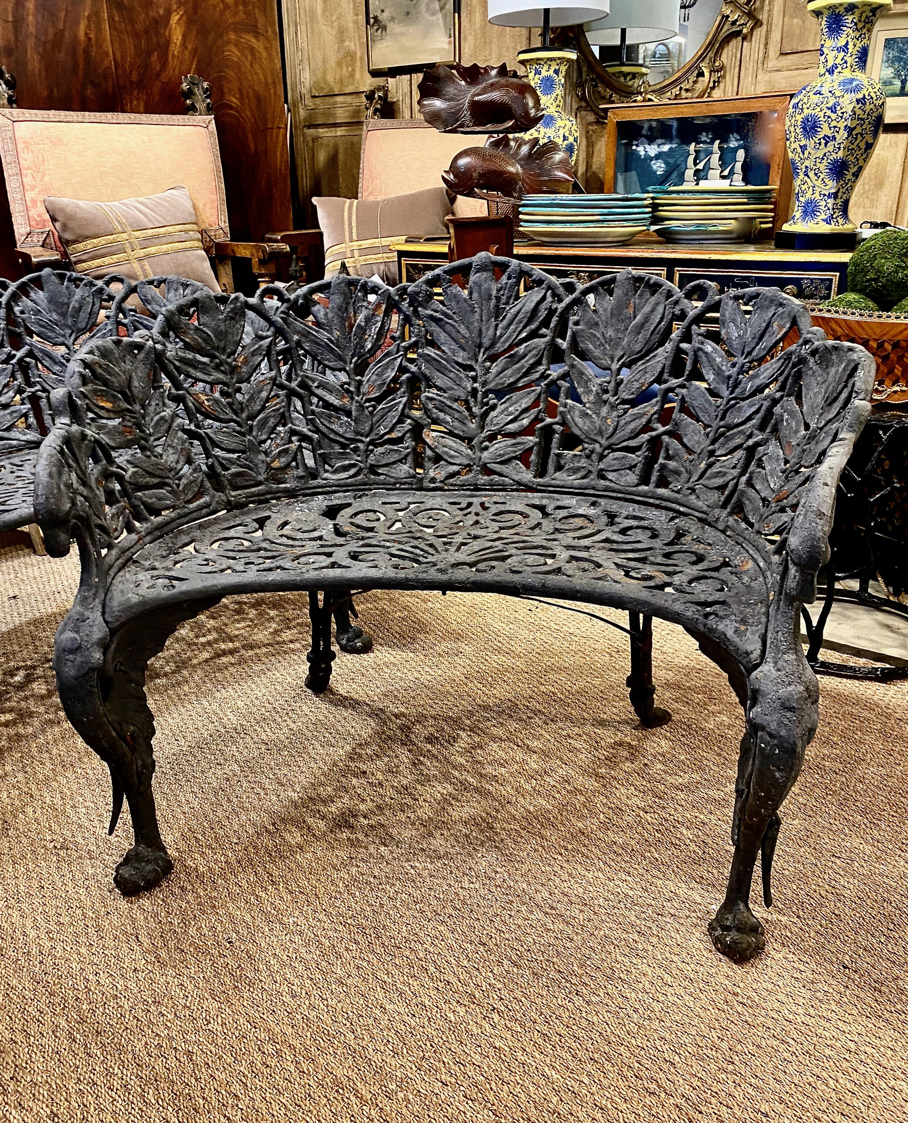 This is an extraordinary pair of Victorian cast iron benches in a fern pattern. The iron casting is of the highest level of artistry and craftsmanship. The front supports are in the form of winged griffins and the back legs seem to be scrolling