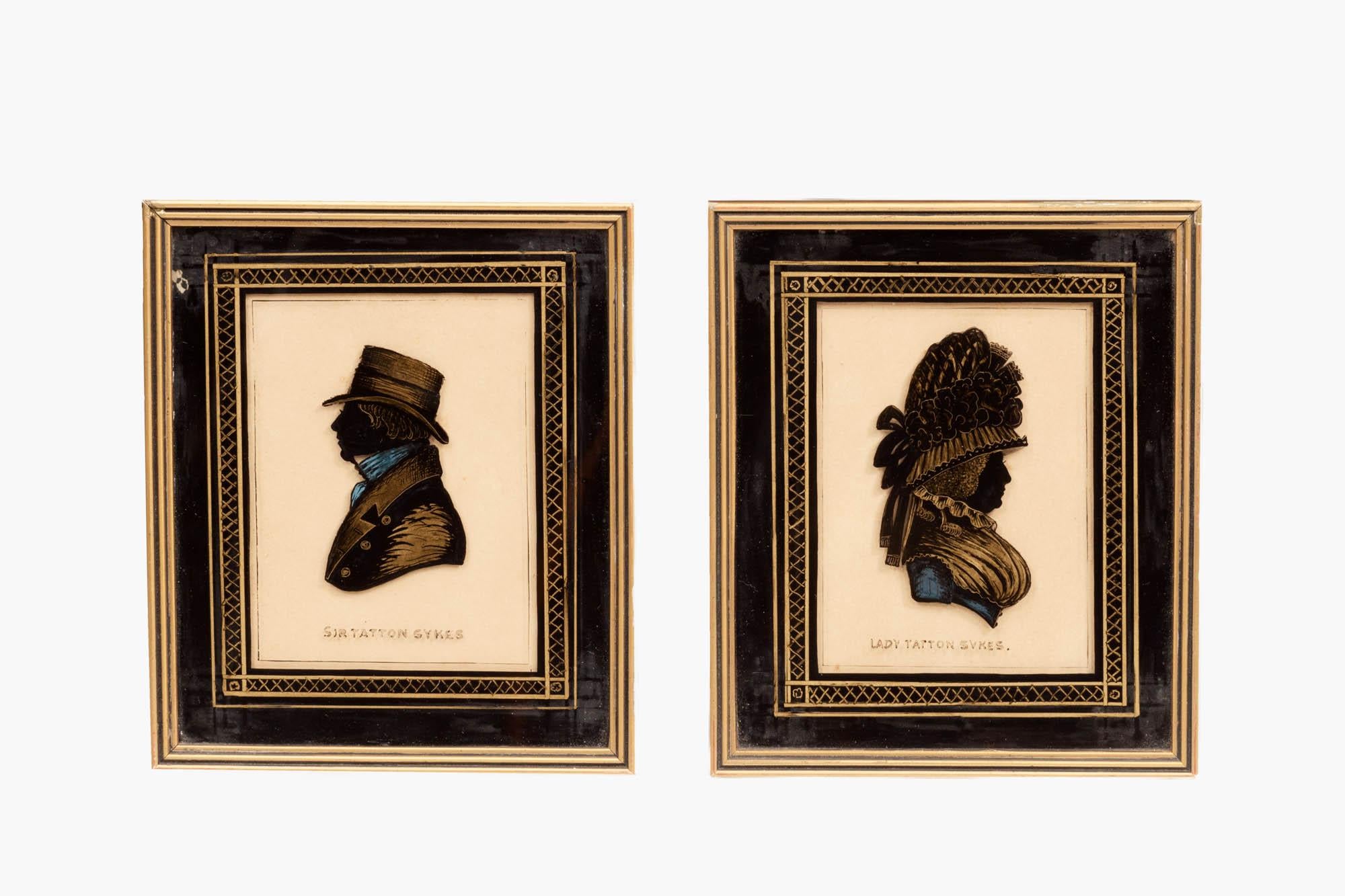 Pair 19th century English miniature silhouettes depicting Sir and Lady Tatton Sykes in profile. These hand-painted silhouettes, also known as profile miniatures, show a gentleman and lady, bust-length in traditional dress of the period, circa