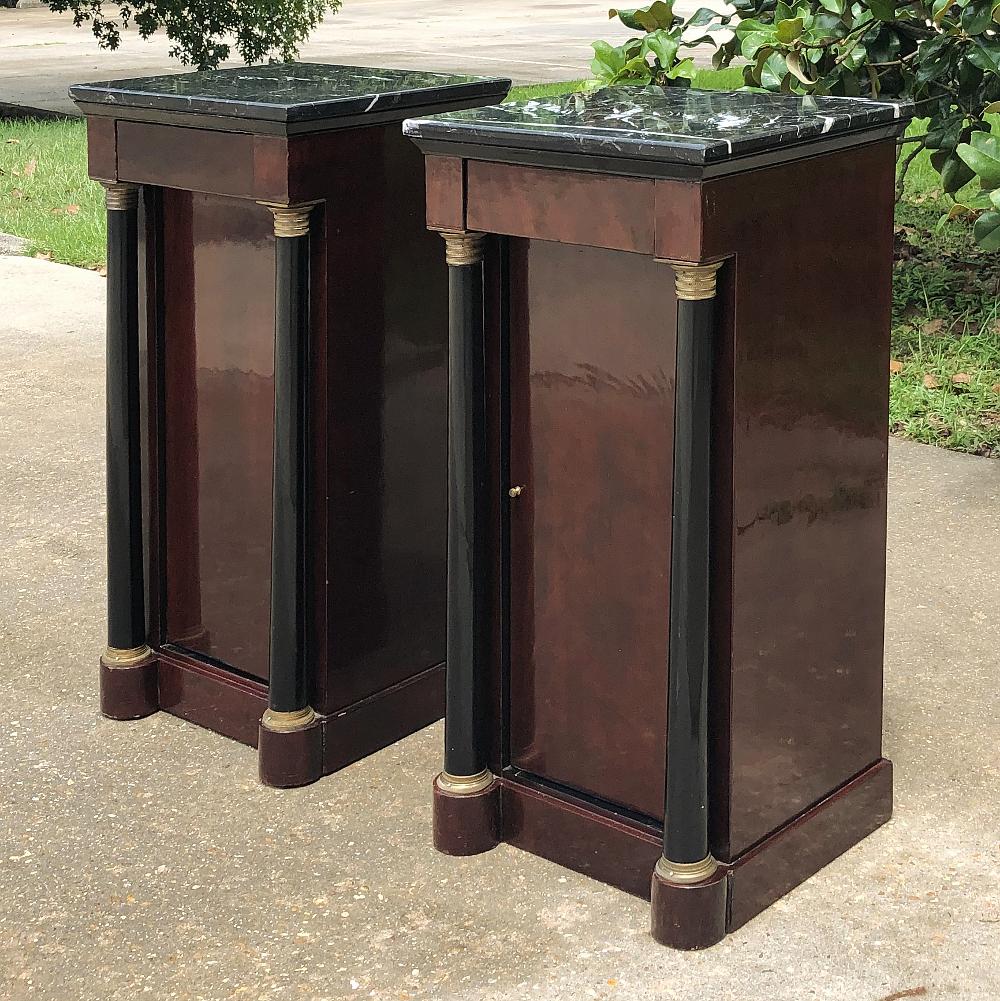 Pair 19th century French 2nd Empire Mahogany marble top nightstands were crafted during the 2nd Empire during the reign of Napoleon III feature the luxurious and exotic wood imported from the Americas embellished with subtle bronze accents. Turned