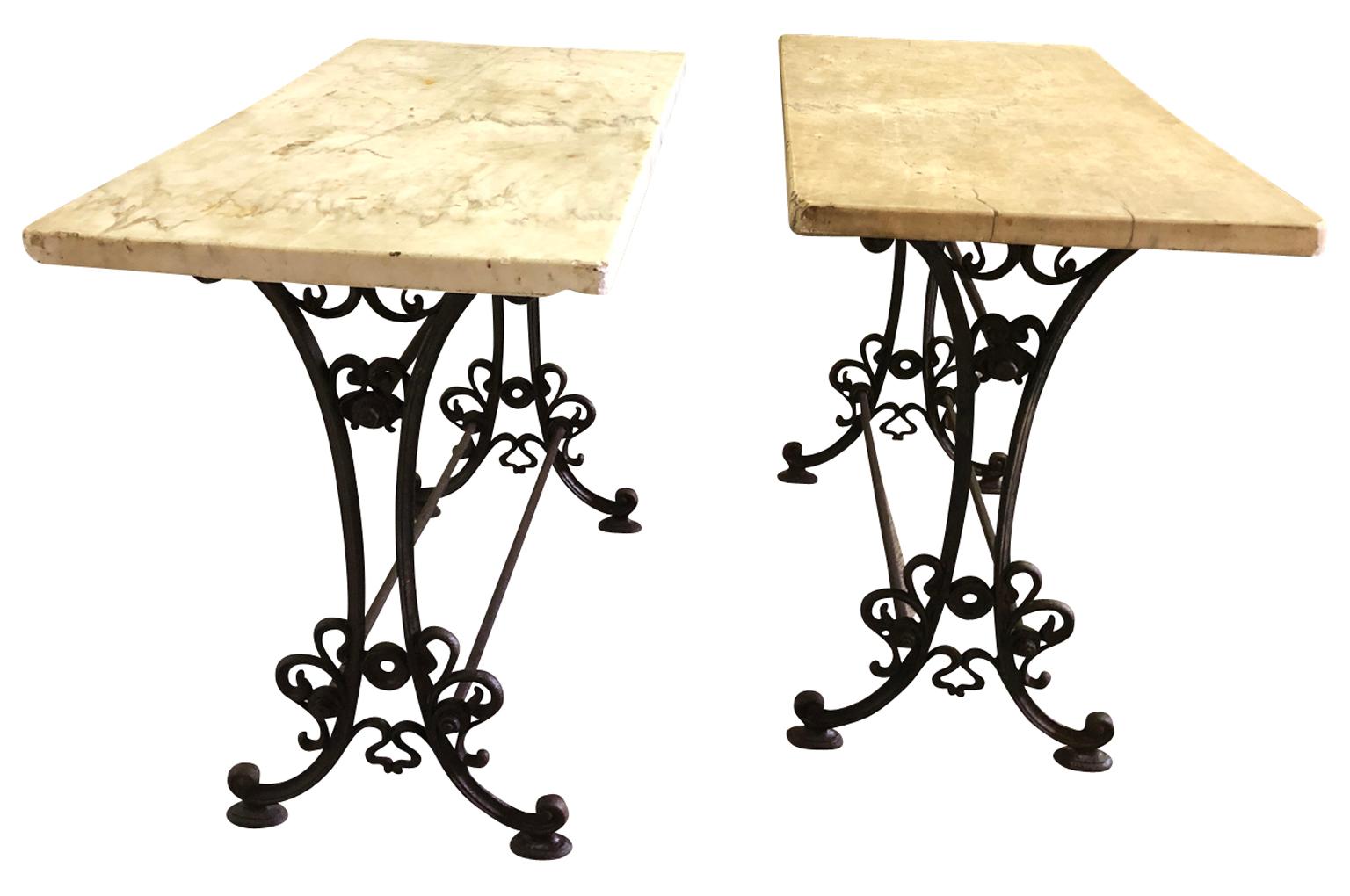 A very charming pair of mid-19th century Bistro Tables from the Provence region of France. Wonderfully constructed with beautiful cast iron bases and original marble tops. Perfect for any interior or garden.