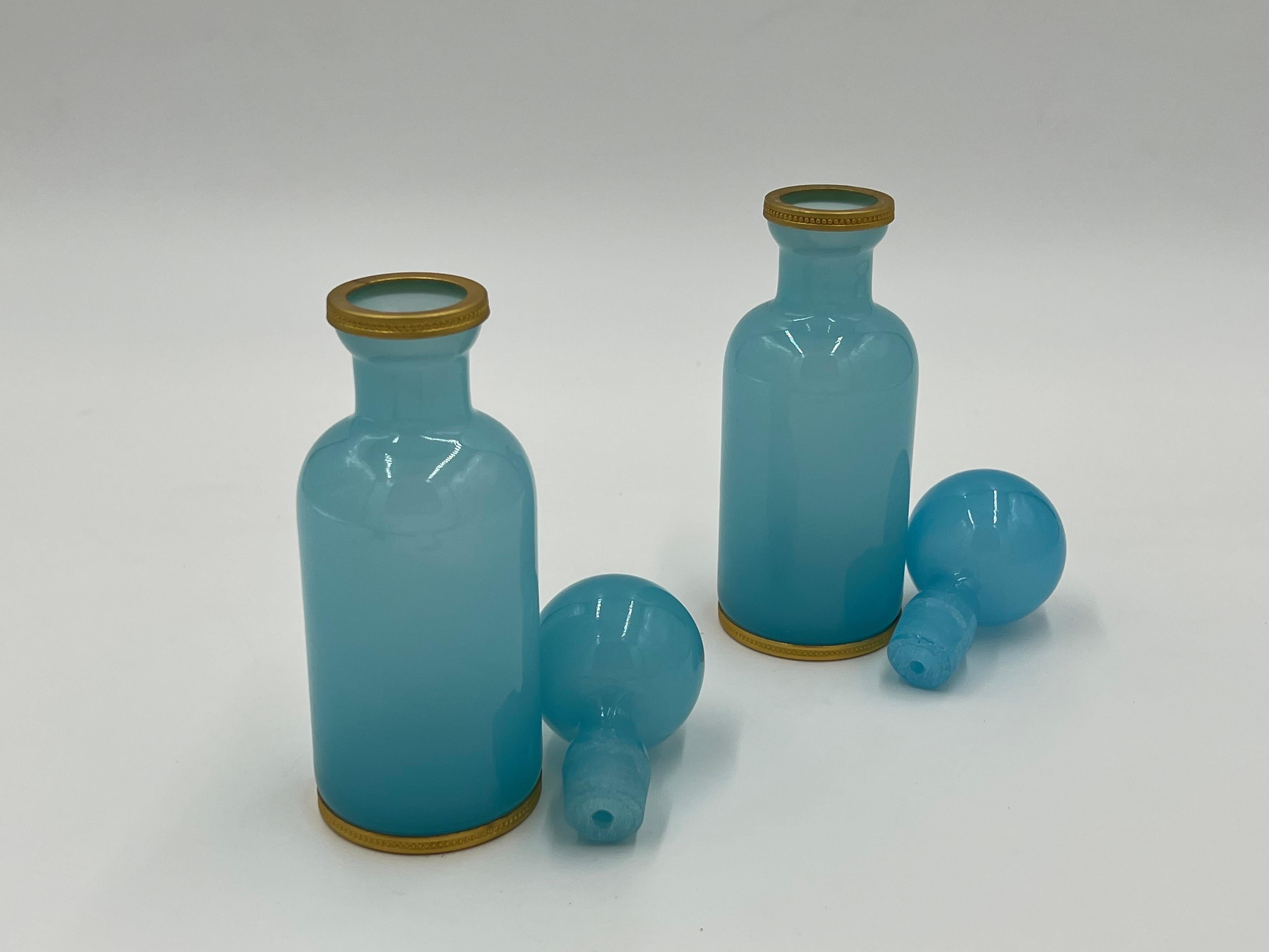 Pair, 19th century French blue opaline ormolu mounted glass perfume bottles. 
Each bottle with ormolu mounts to base and upper rims. Matched pair with no marks apparent. 
Measures: 7.5” H x 2.5” W.