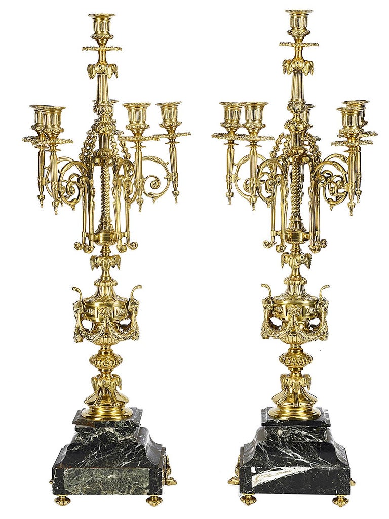 A pair of good quality 19th century green marble and ormolu six branch candelabra, each with urn, swag and foliate decoration.