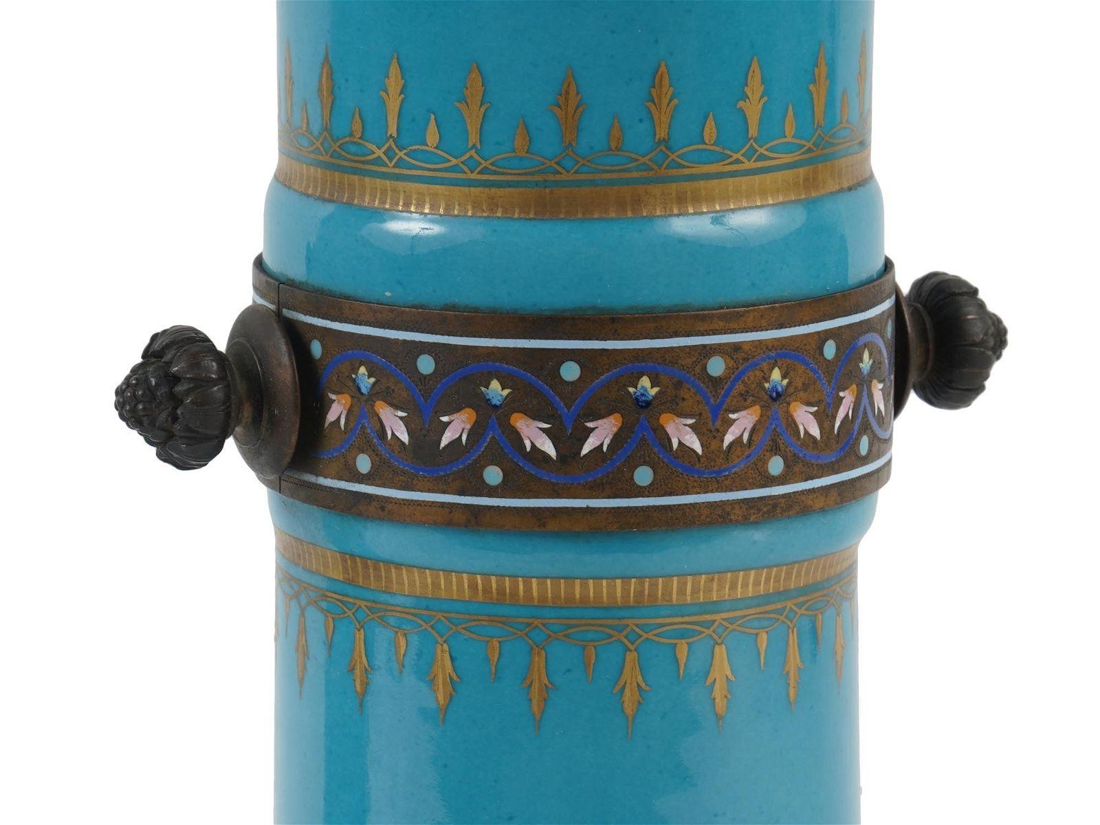 Paire de porcelaines anciennes (19e siècle)  vases à finition bleu clair avec décorations dorées et bande de bronze et d'émail champlevé avec poignées à fleur.  Chacun mesure 13 5/8 pouces de haut.