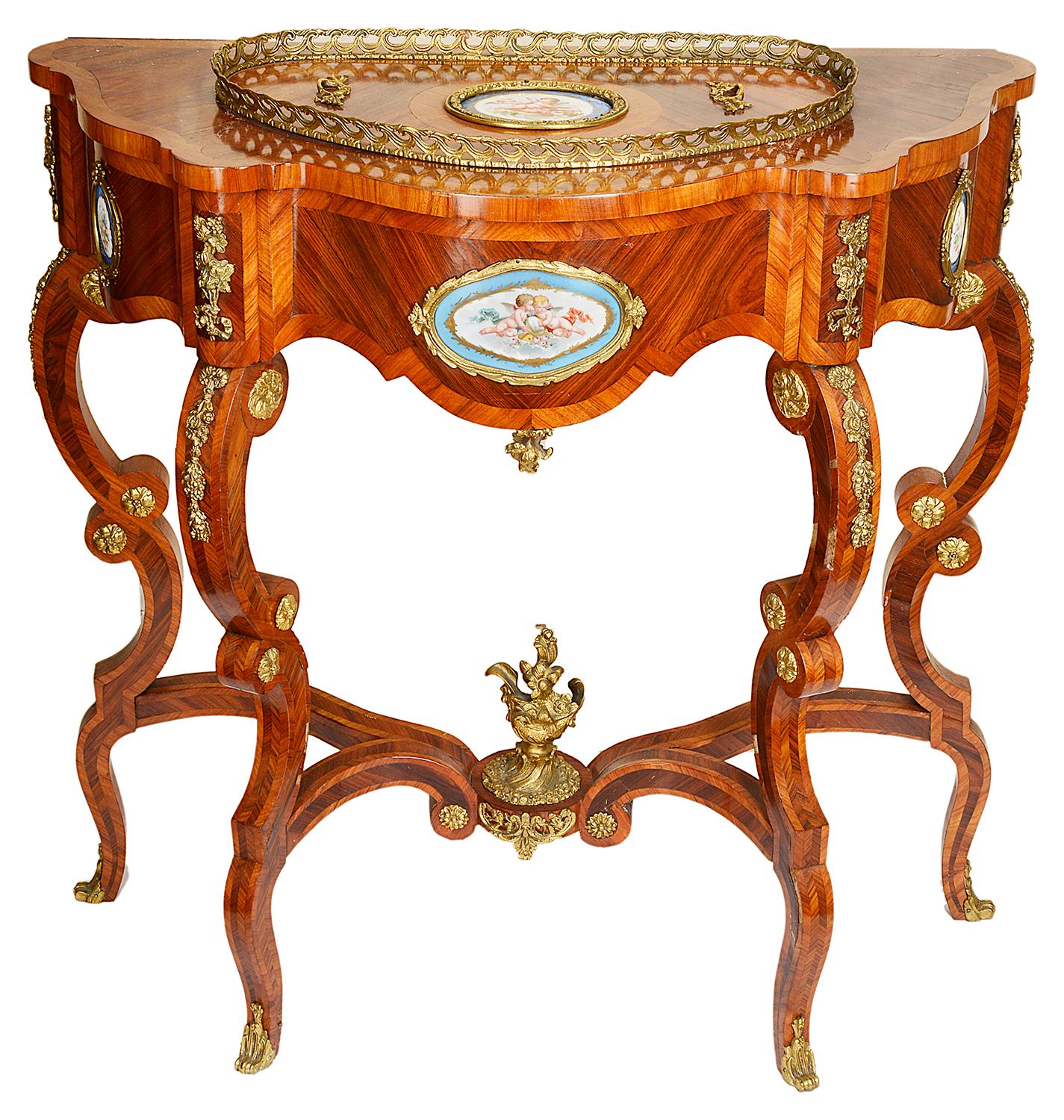 A striking pair of French late 19th century console / jardinière tables, each with gilded ormolu gallery and mounts, Sevres style porcelain plaques, united by an under tier stretcher and raised on elegant scrolling cabriole legs. The lid to the top