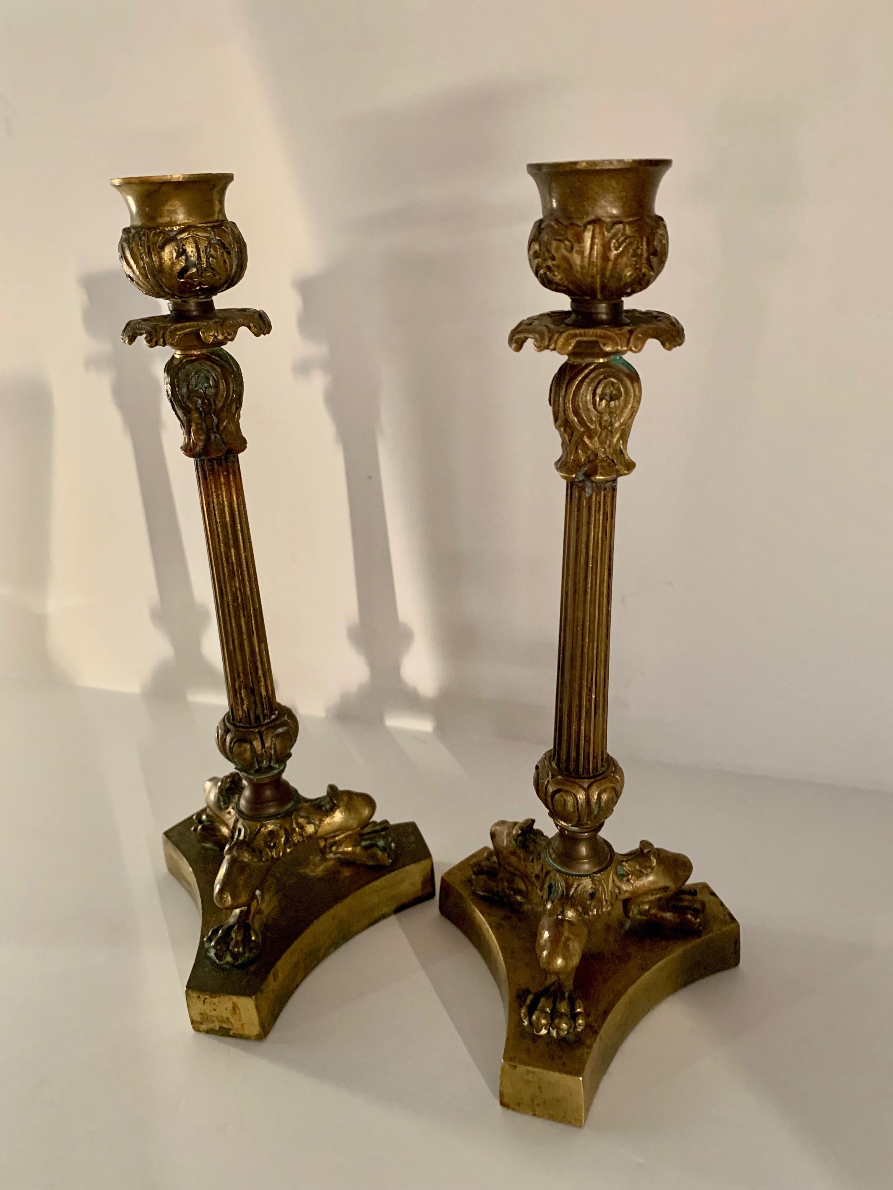 A handsome pair of 19th century French Empire candlesticks, an urn atop a column supported by lions paw feet... lovely on a dinner table, in the den or start something steamy in your bedroom with candle light! (I won't tell).