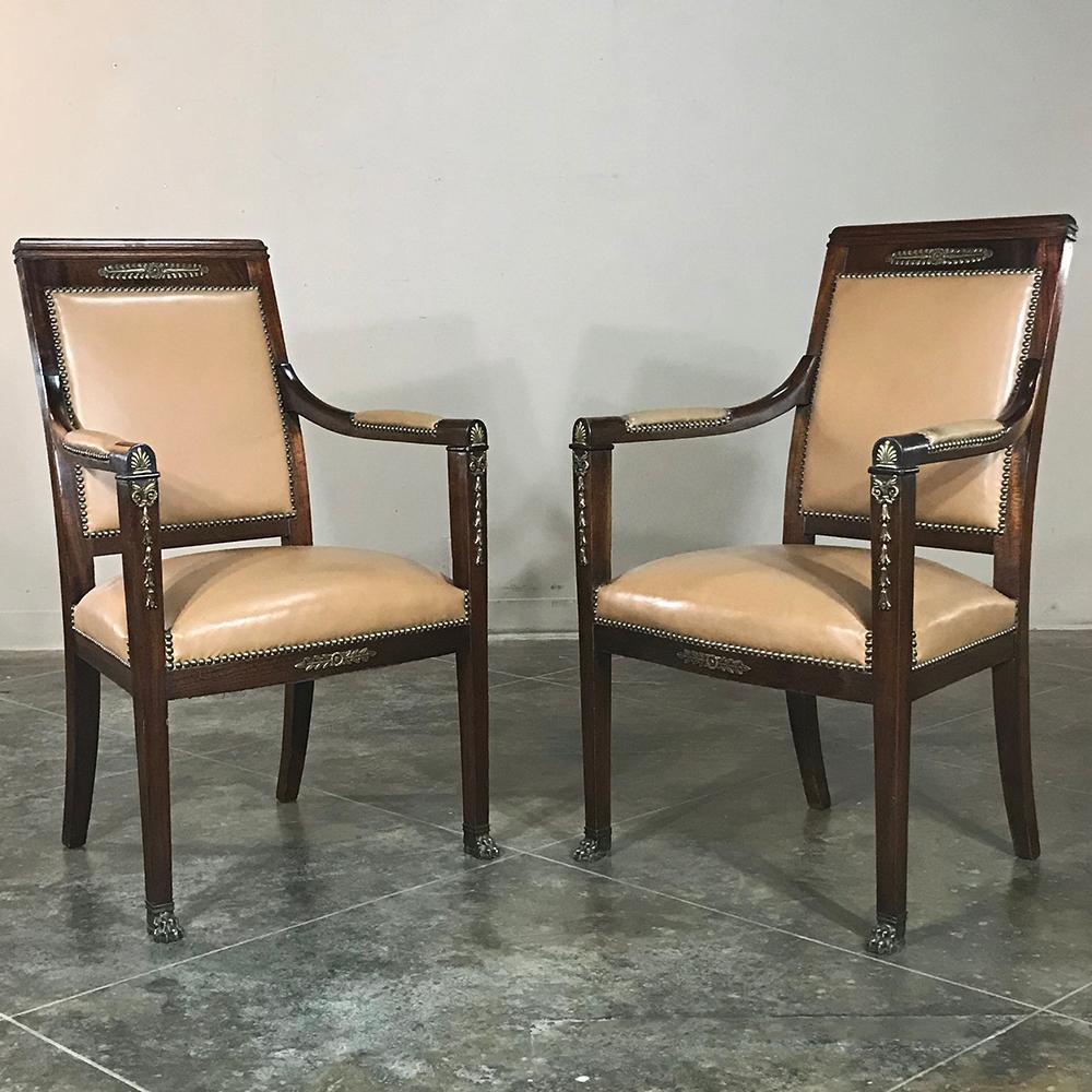 Pair 19th century French Empire Mahogany armchairs with leather & bronze mounts are ideal for the Conference Room, an office environment, a large game table, or just to use around the home to create comfortable seating groups in style! Hand-crafted