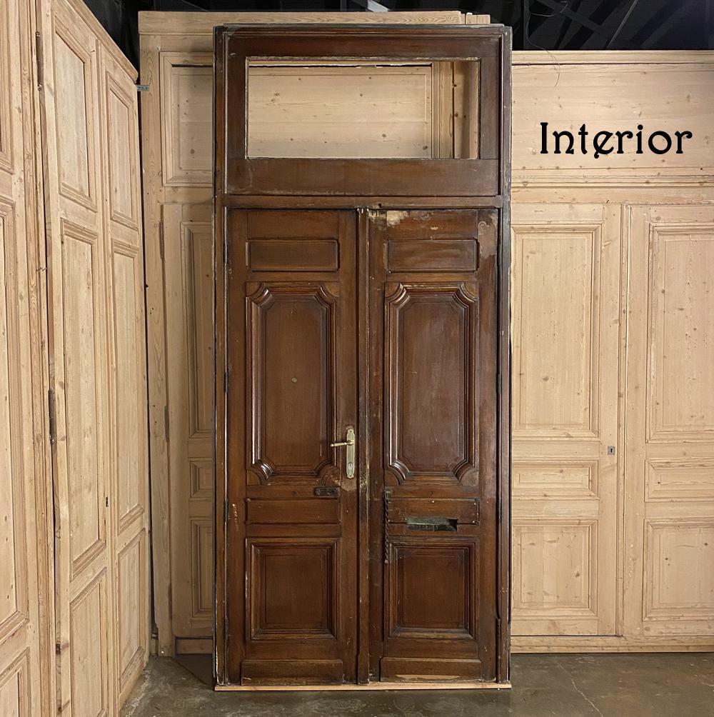 Pair of 19th century French exterior doors in frame is ready to create a majestic entrance to your new or renovated home! Bold molded detail appears in abundance from the crown between the transom and the doors themselves, all the way down to the