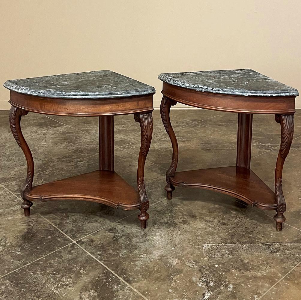 Pair 19th century French faux marble top corner consoles are exceedingly rare to find in a pair, and were hand-crafted then carved to perfection from fine French walnut. Each features boldly scrolled and carved cabriole legs which are connected to