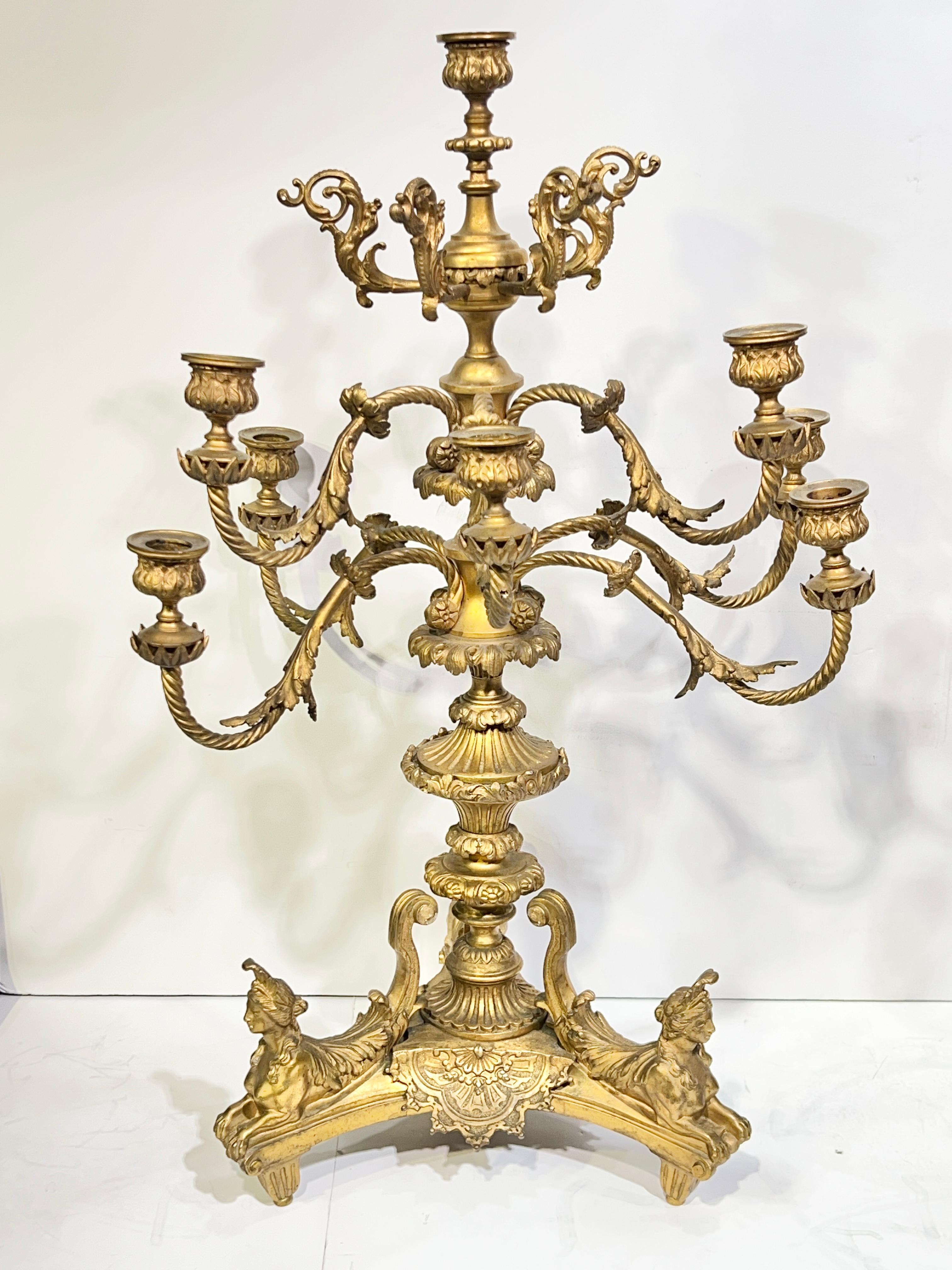 Pair of antique (19th century) French gilt bronze 8-light candelabra after the original 14th century model by André Charles Boulle (1642-1732) measuring 24.5 inches tall, 16 inches wide and 13 inches deep.