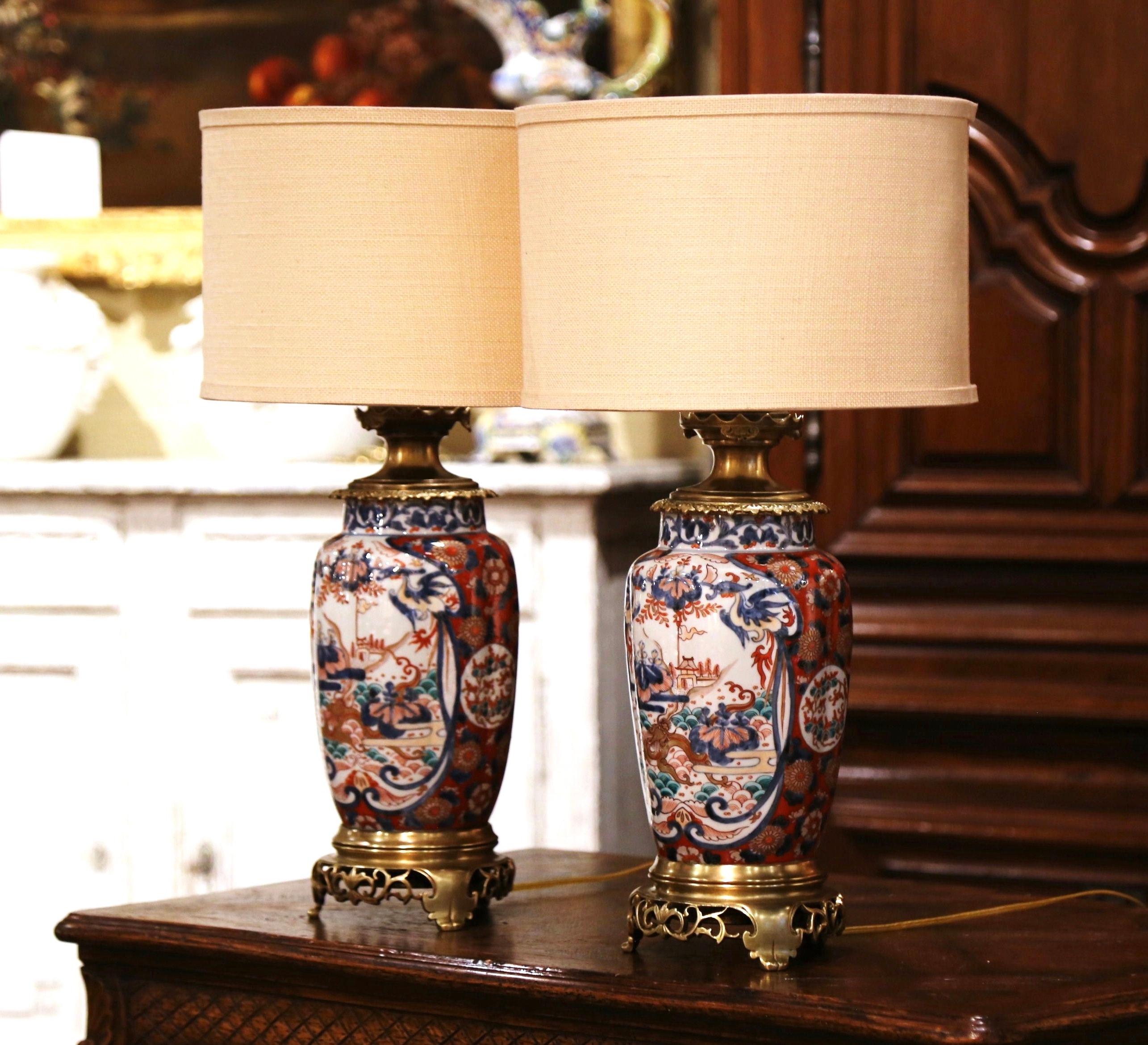 Add the perfect amount of chinoiserie into your home with this decorative pair of antique lamps. Created in France circa 1920, and round in shape each porcelain lamp rests on a bronze base, and is decorated at the neck with a bronze mount. The