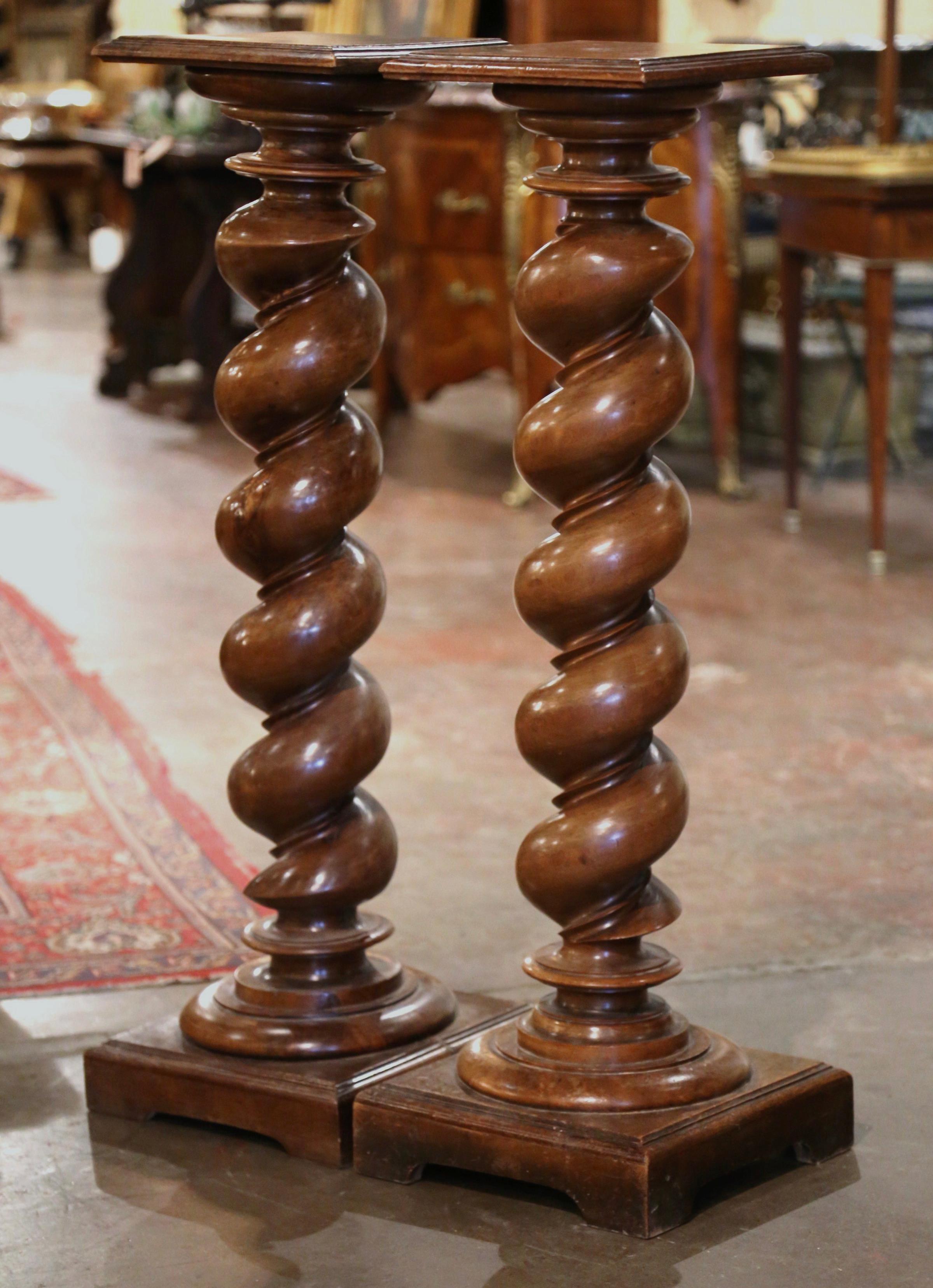 Display a bust or a flower vase on these elegant, antique pedestals. Crafted in Southern France circa 1870 and built of walnut, each column sits on a thick decorative square plinth ending with bracket feet. The fruit wood pedestal features a hand