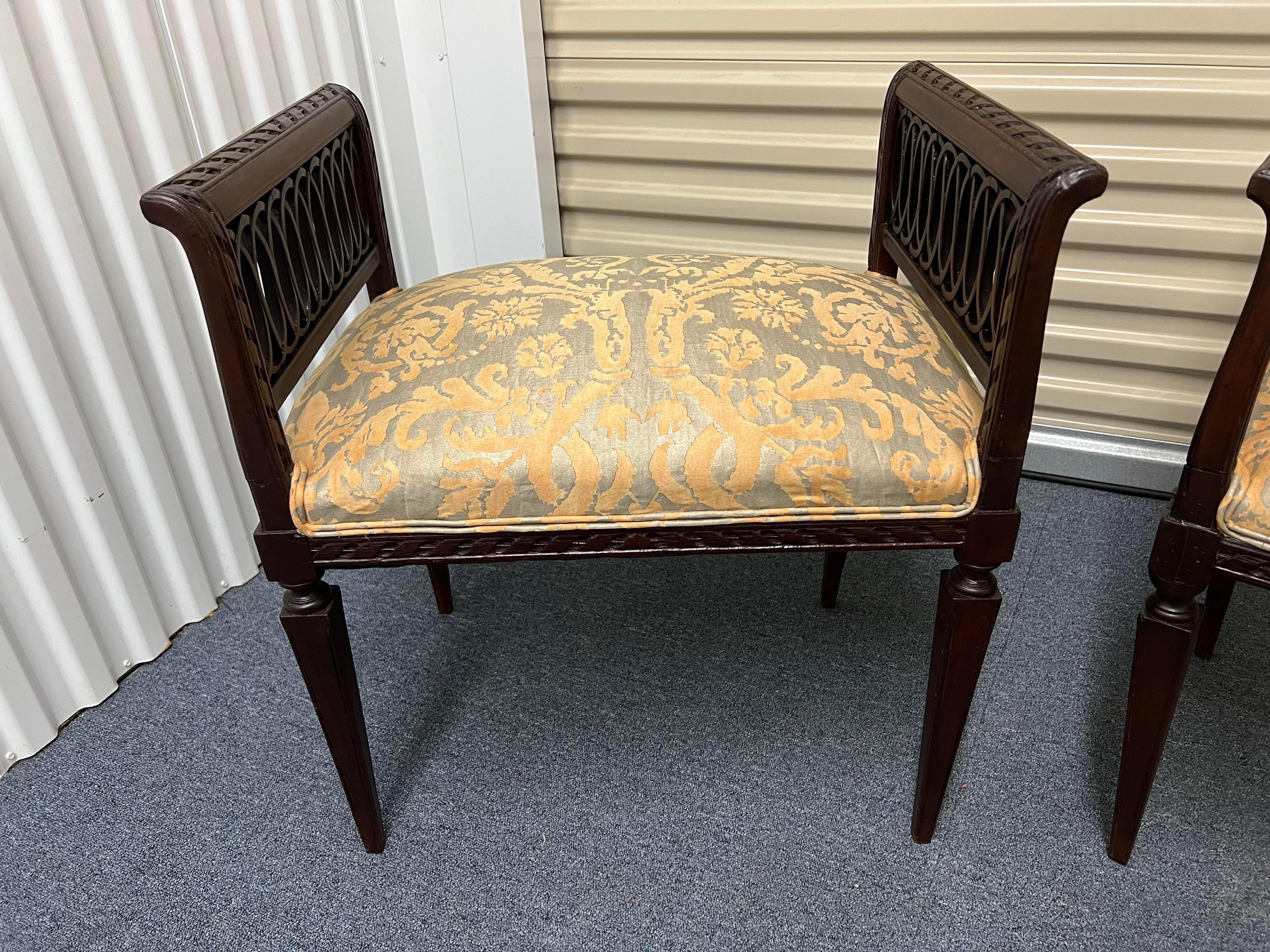 A pair of fine 19th century french louis xvi style stools or benches with authentic Fortuny fabric! Beautiful carvings to edges.

26” h x 23” w x 16.5” d x 21.5” (seat height)