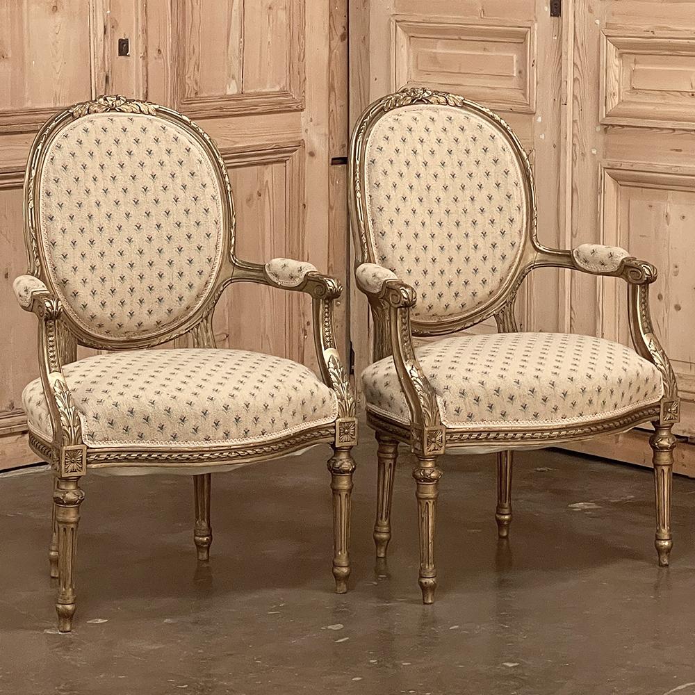 Pair 19th Century French Louis XVI Gilded Armchairs ~ Fauteuils are a truly timeless representation of the neoclassic form inspired by the ancient Greeks and Romans! Carved from hand-select hardwood, each features an oval, contoured seat back and