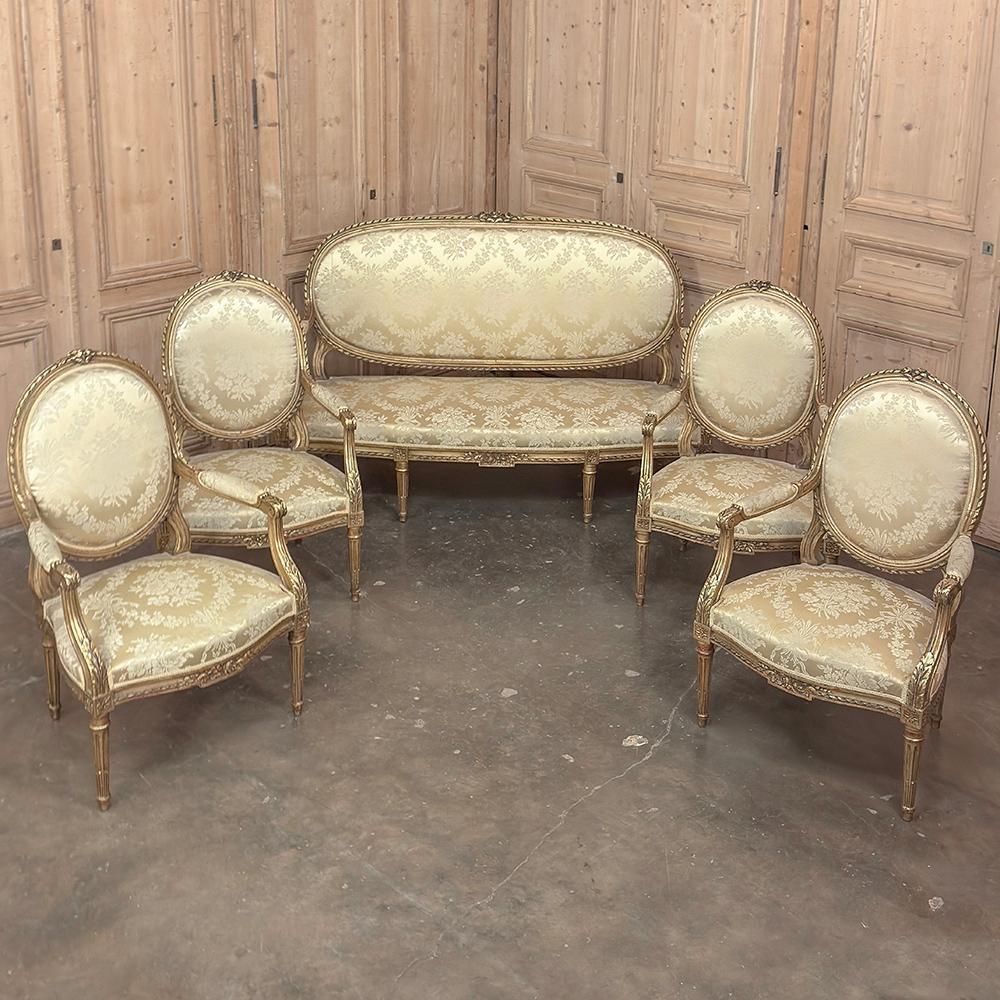 Pair 19th Century French Louis XVI Giltwood Armchairs ~ Fauteuils will make a splendid addition to any room!  Hand-crafted from select hardwood then given a gilt finish, each frame is hand-carved with floral, spiral ribbon and acanthus leaf motifs. 