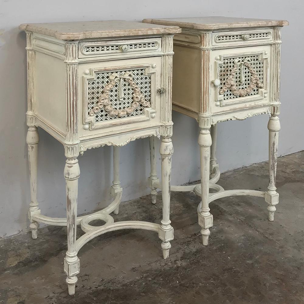Pair of 19th century French Louis XVI painted marble top nightstands exude the classical architecture that was revived during the middle of the 18th century and has remained popular for over 3 millennia! This pair, with caned doors overlaid with