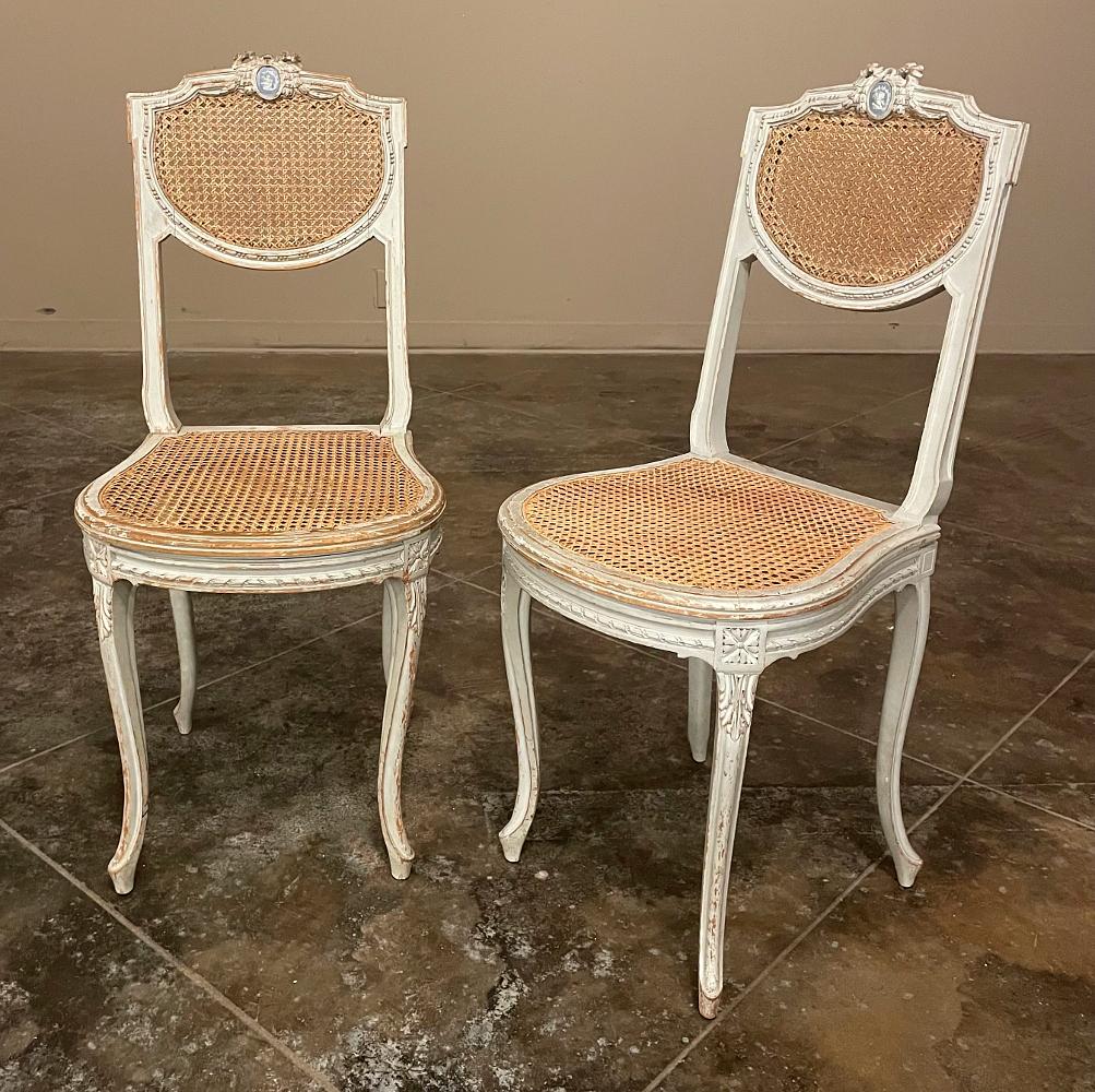 Pair of 19th Century French Louis XVI Painted Salon Chairs is a great choice for occasional use anywhere in the home! Four subtly scrolled cabriole legs carved with acanthus plumes provide support, with an apron encircled with spiral ribbon and