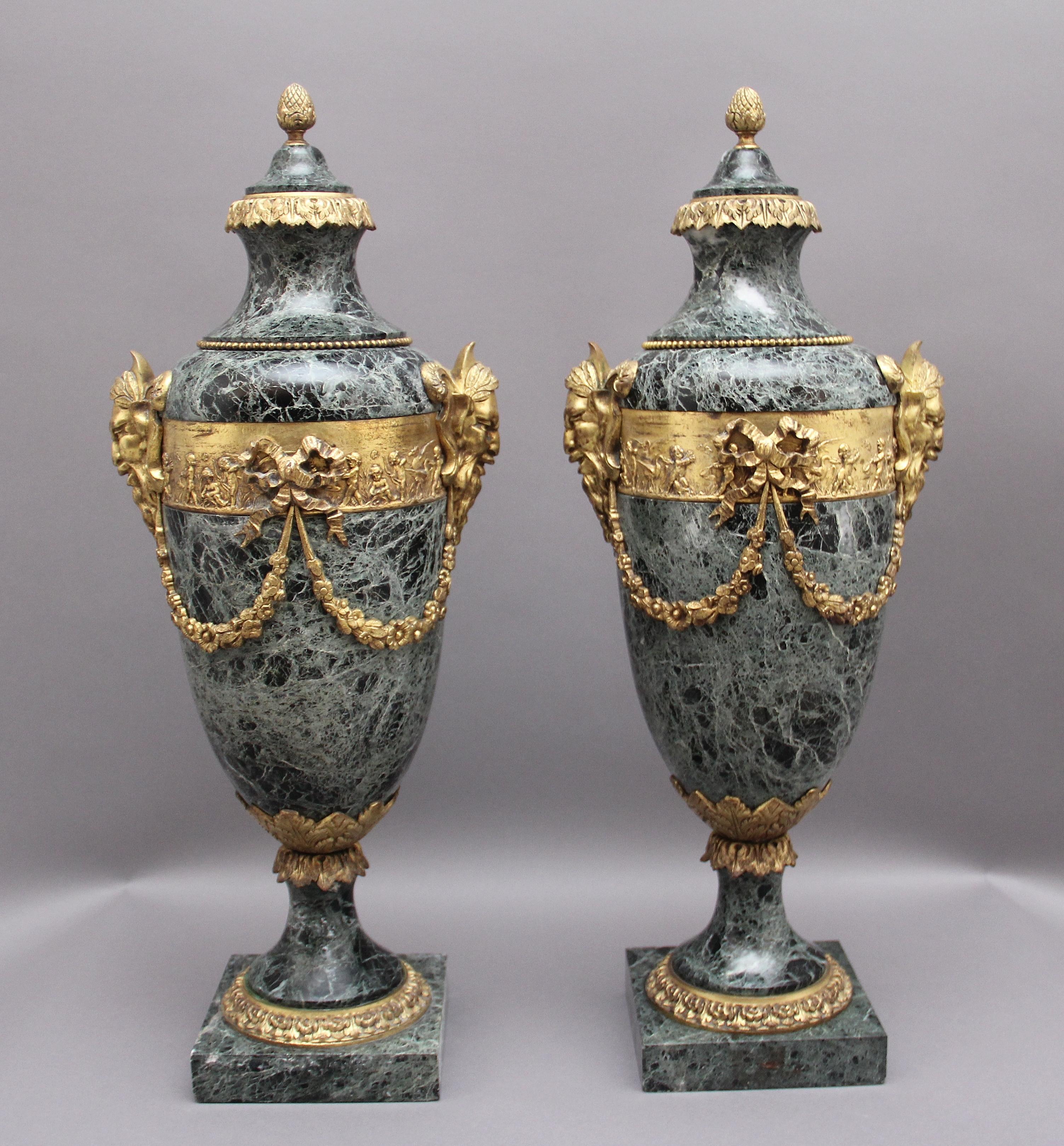 A stunning pair of French 19th Century marble and ormolu cassoulet urns, the green marble urns decorated with lovely quality ormolu including the finial and floral sash, either sides of the urns are ormolu satyr masks, ornate ormolu beading at the