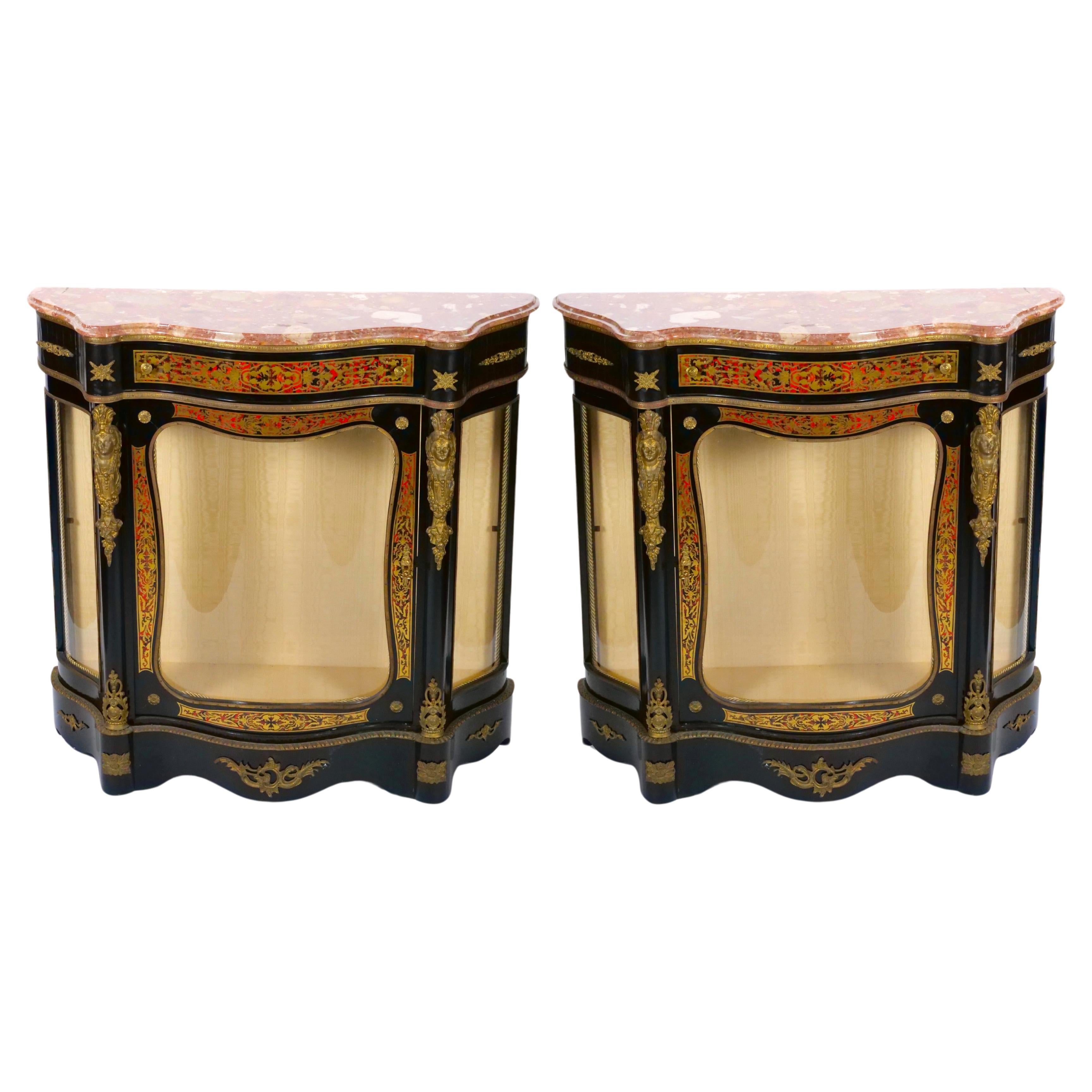 Elevate your living space with this Pair of Antique Napoleon III Ebonized Demilune Shaped Side Cabinets, a remarkable display of opulence and craftsmanship. These cabinets are more than just functional storage units; they are exquisite pieces of