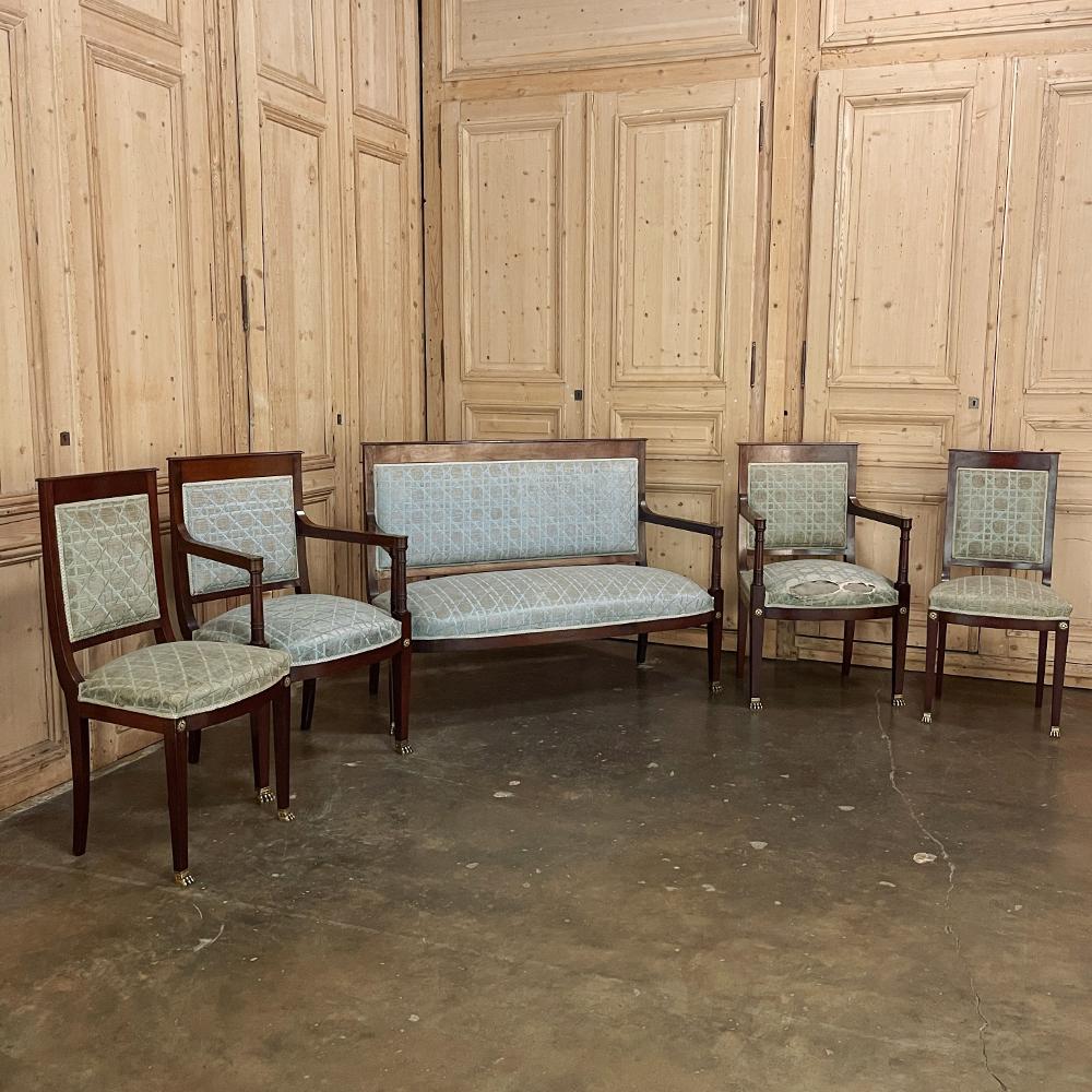 Pair 19th century French Napoleon III Period Mahogany armchairs reflects the stately classically-inspired architecture of the ancients, accentuated by bronze castings of rosettes and lions' paw feet which contrast beautifully with the rich