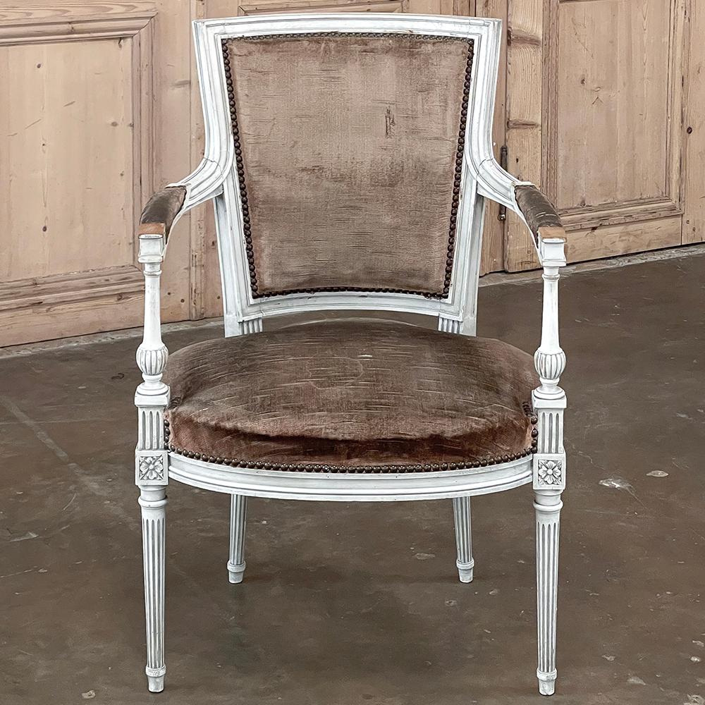 Antique French Louis XVI Painted Armchair represents a style transition into the Directoire look, where a more tailored design created a cleaner appearance. The squared off, contoured seat back combines with a generous seat for comfort, especially