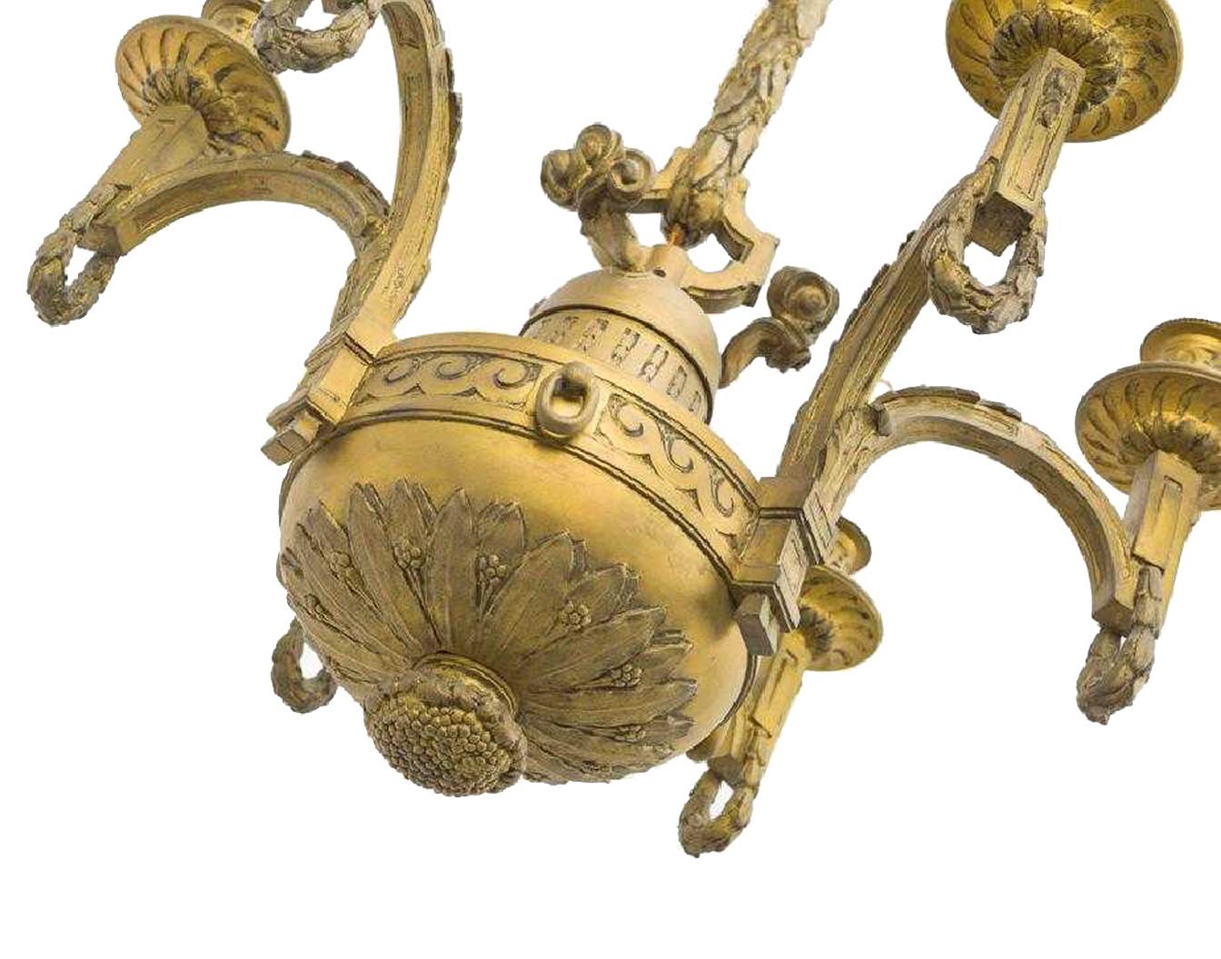 Extremely fine pair of 19th century French Louis XVI style ormolu six-light chandeliers, late 19th century. 
Possibly Linke.
The original gilt bronze canopy and chain is over an ormolu center shaft with well-chaised Greek key and wheatgrass leaves,