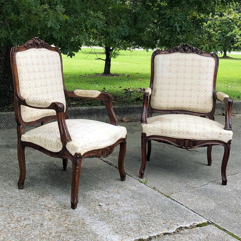Pair 19th century French Regence walnut armchairs ~ Fauteuils is an incredibly elegant set, with the sumptuous wood, considered the finest indigenous furniture wood in Europe, skillfully and artfully sculpted with shell, floral and foliate motifs on