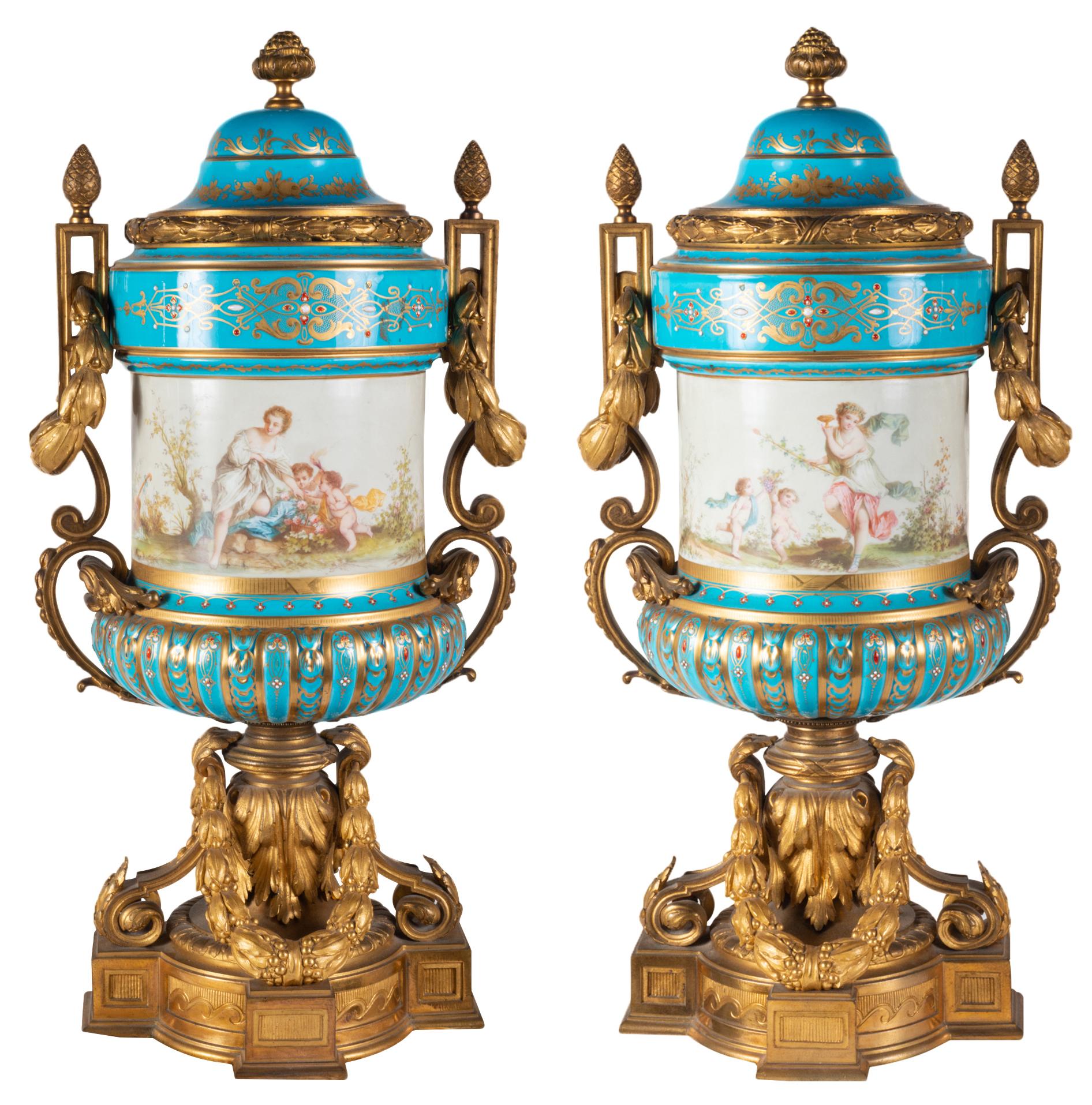 A fine quality pair of late 19th century French 'Sevres' style lidded vases, each with a turquoise ground, depicting classical romantic scenes, wonderful gilded ormolu C-scroll and swag mounts.