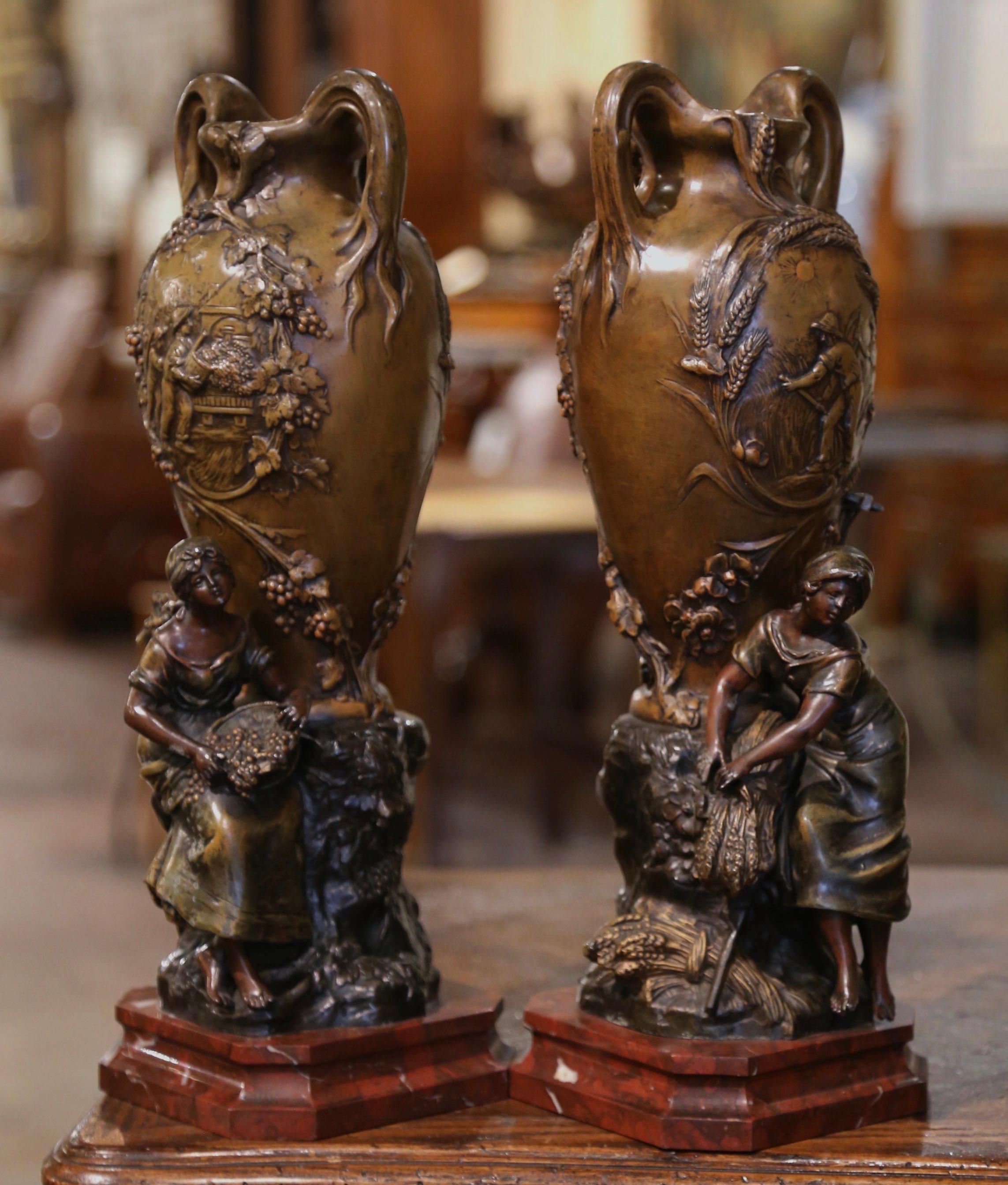 Decorate a mantel, console or buffet with this elegant pair of antique vases. Crafted in France circa 1880 and made of spelter (or white metal), the vases stand on a square red marble base. Signed on the base by French sculptor Francois H Moreau,