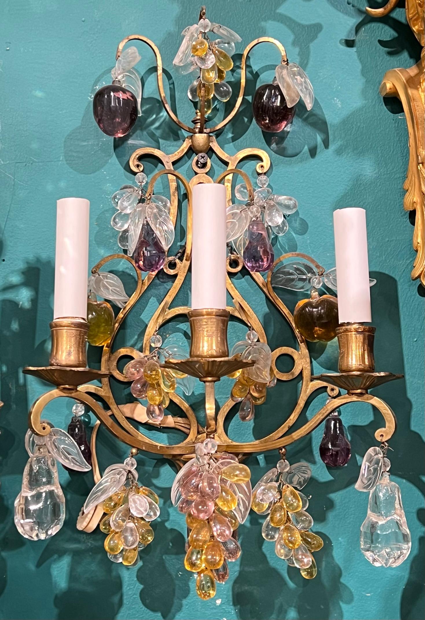 Pair of bronze lyre form wall lights with numerous fruit shaped clear and colored glass pendants in the shapes of grape bunches, pears and apples.  With three candelabra-size sockets and wiring, ready for use.