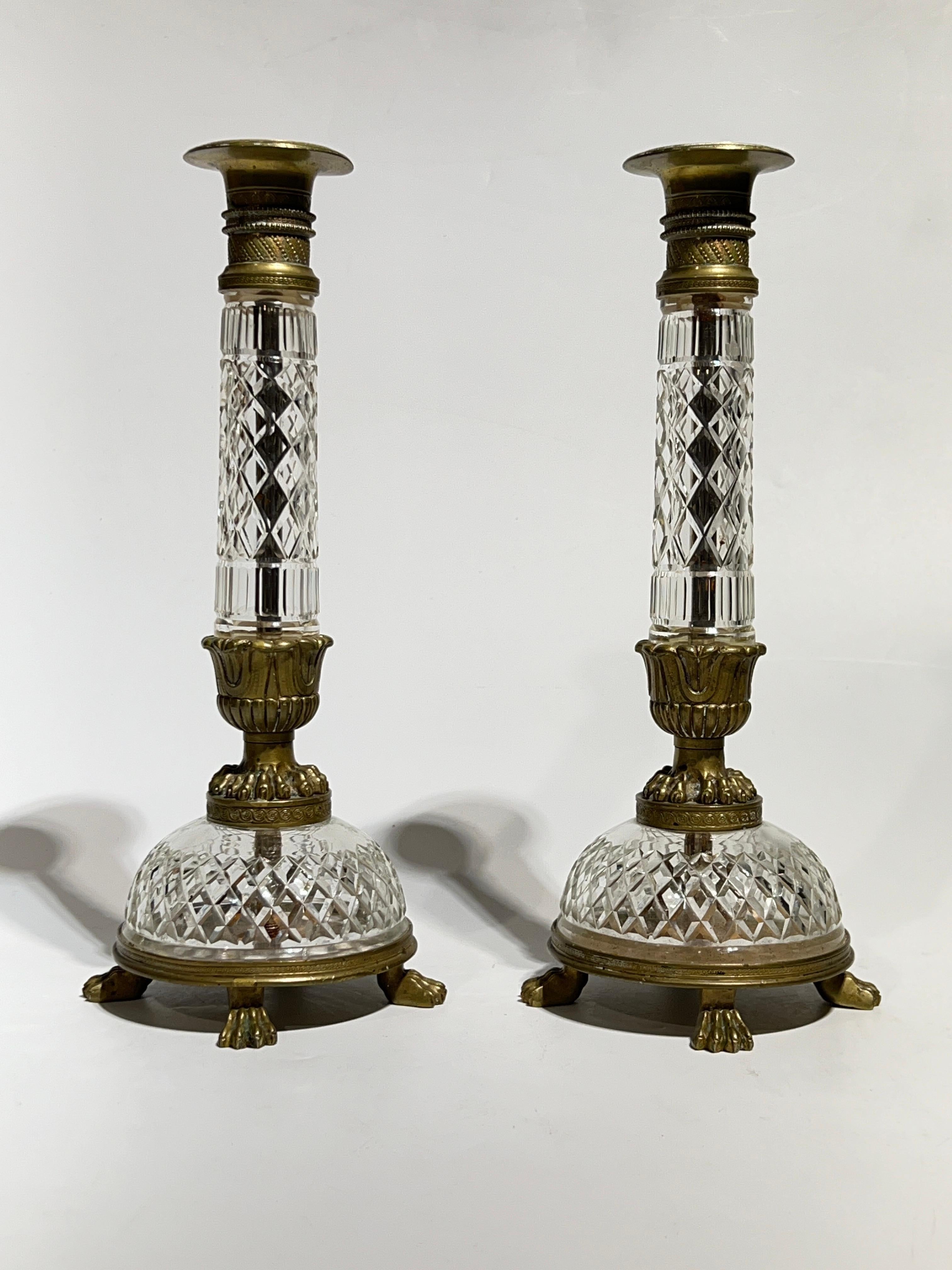 Paire de chandeliers anciens en bronze de style Empire  en verre taillé, avec des bougeoirs en bronze et des pieds en patte de lion.  D'une hauteur de 12 pouces, elles sont toutes en très bon état.