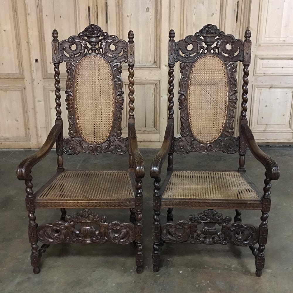 Pair 19th century Grand Renaissance Hand Carved oak & caned armchairs is a remarkable example of the sculptor's art, with the added benefit of lightweight caning on the seat and seatback which are also very cool for summertime use! Each has been
