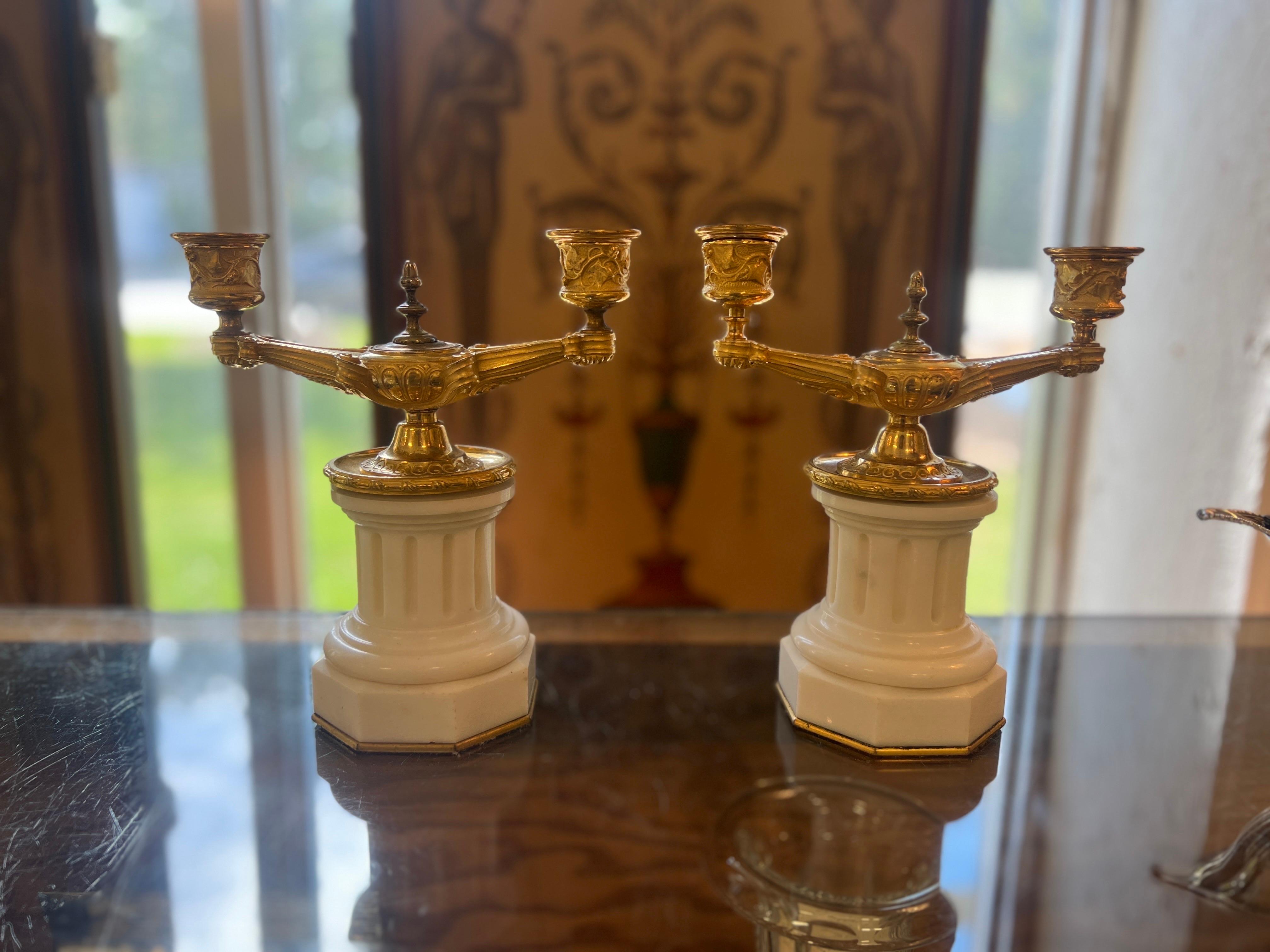Italian or French, early 19th century.

A fantastic pair of 19th century Grand Tour gilt bronze candelabras in the neoclassical taste. The beautiful cast grape vines to the candle arms, scrolled arms extending off a genie lamp style body. Each
