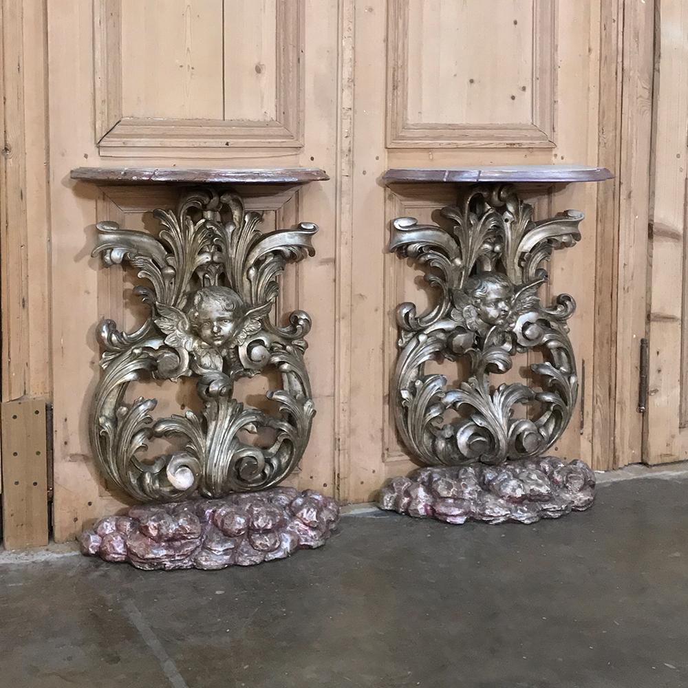 Pair of 19th century Italian baroque giltwood consoles were sculpted by a master at his art from solid wood, then given a gold finish that has achieved a lovely patina over the past century. The base resembles rocks, with a contoured top for