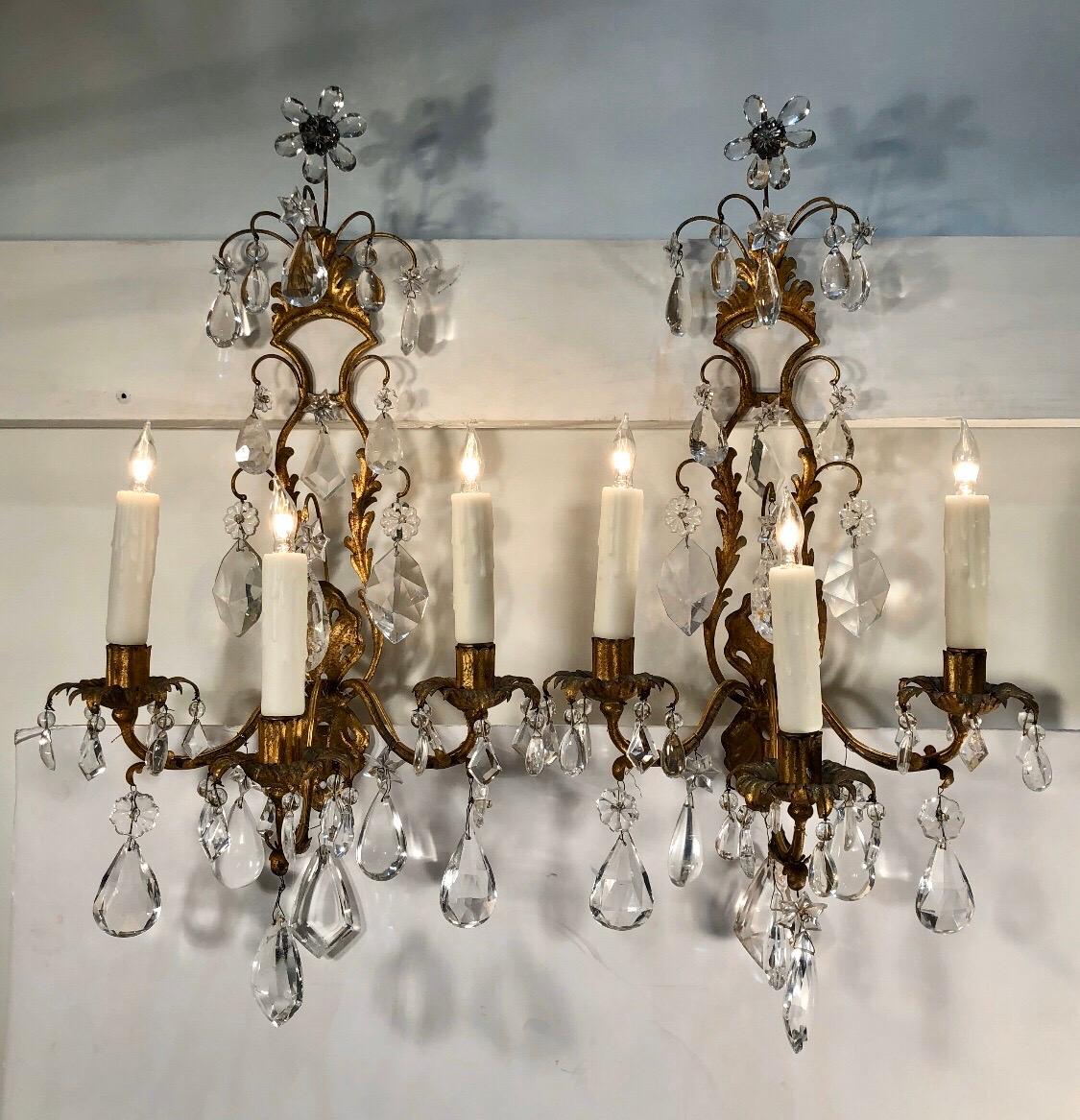 Pair of regal 19th century piedmont, Italy gilt Tôle rock crystal sconces. Each sconces has an iron frame wrapped in Tôle gilt Foliages with gilt floral bobeches that were originally candle.