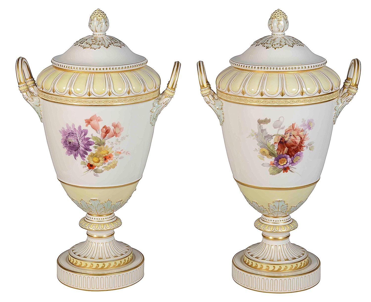 A very good quality pair of late 19th Century Austrian porcelain KPM lidded vases, with cream and white ground, gilded decoration, twin handles to each, hand painted scenes of lovers courting, the reverse side with colourful flowers. raised on