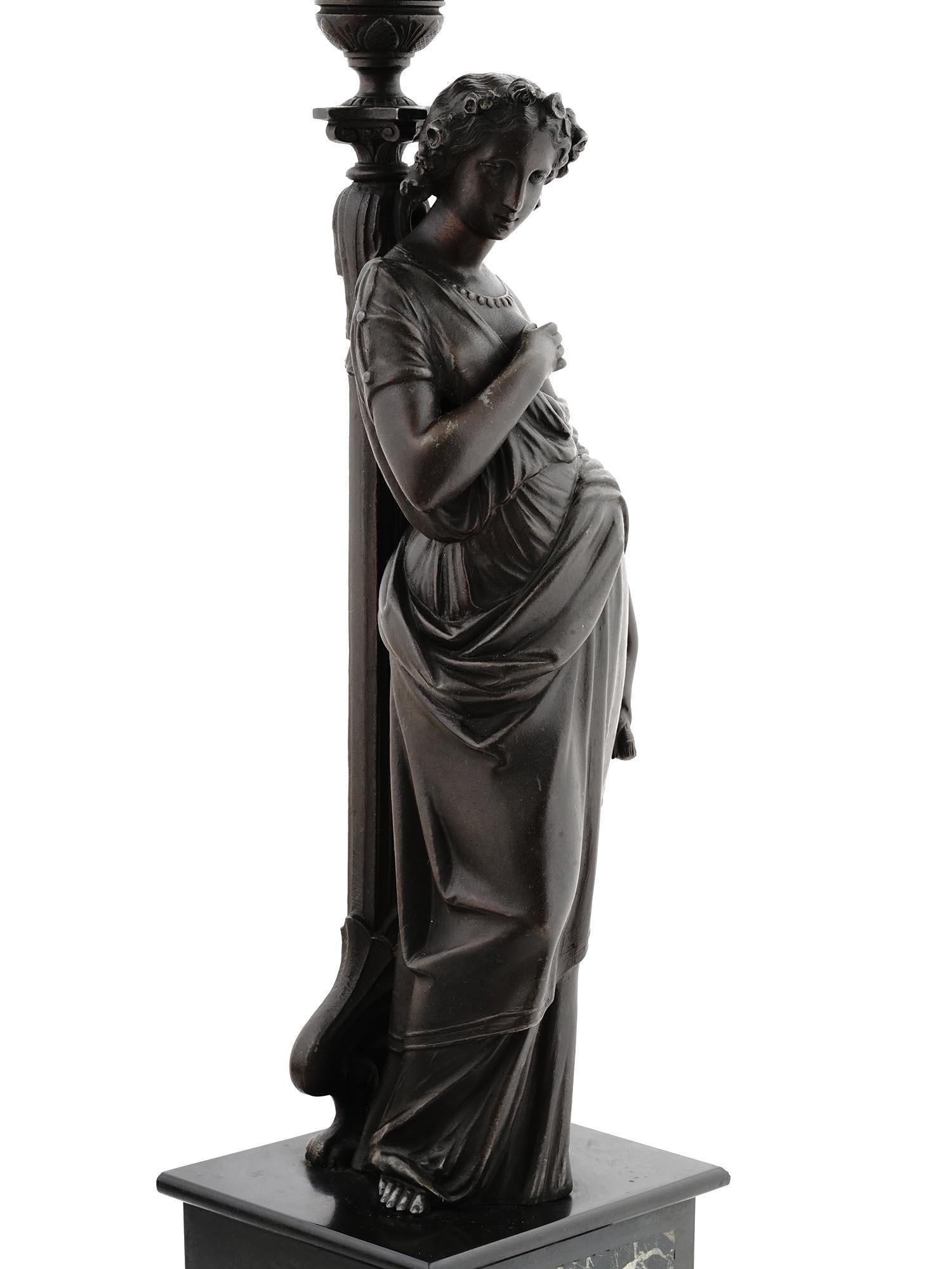 Pair of antique (19th century) French candelabra in the Roman neoclassical style depicting patinated figures of females in classical robes supporting six candle arms and standing on square pedestal bases with variegated marble panels and black slate